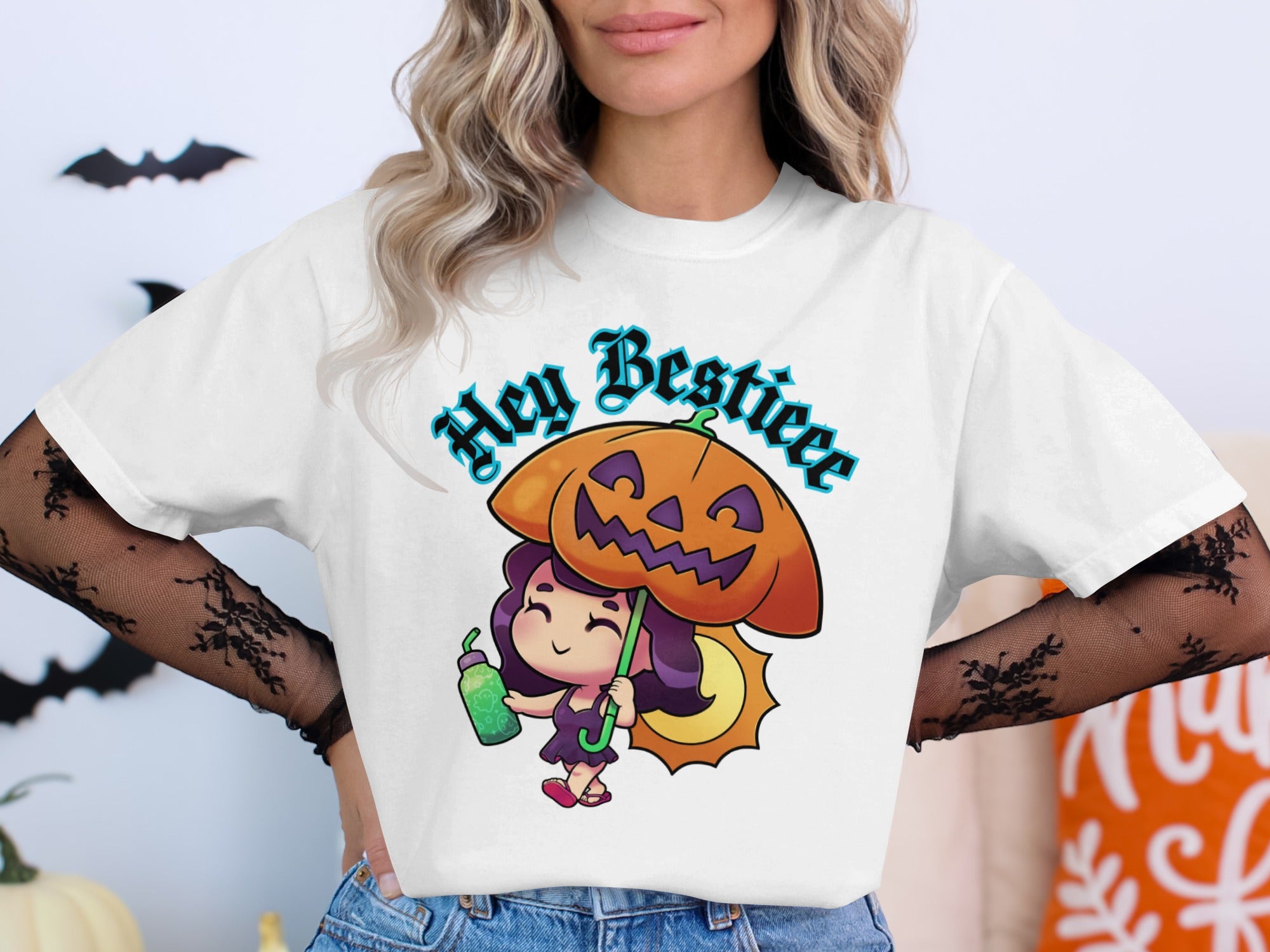 White t-shirt with a cartoon girl holding a pumpkin umbrella and drink, saying "Hey Bestieee".