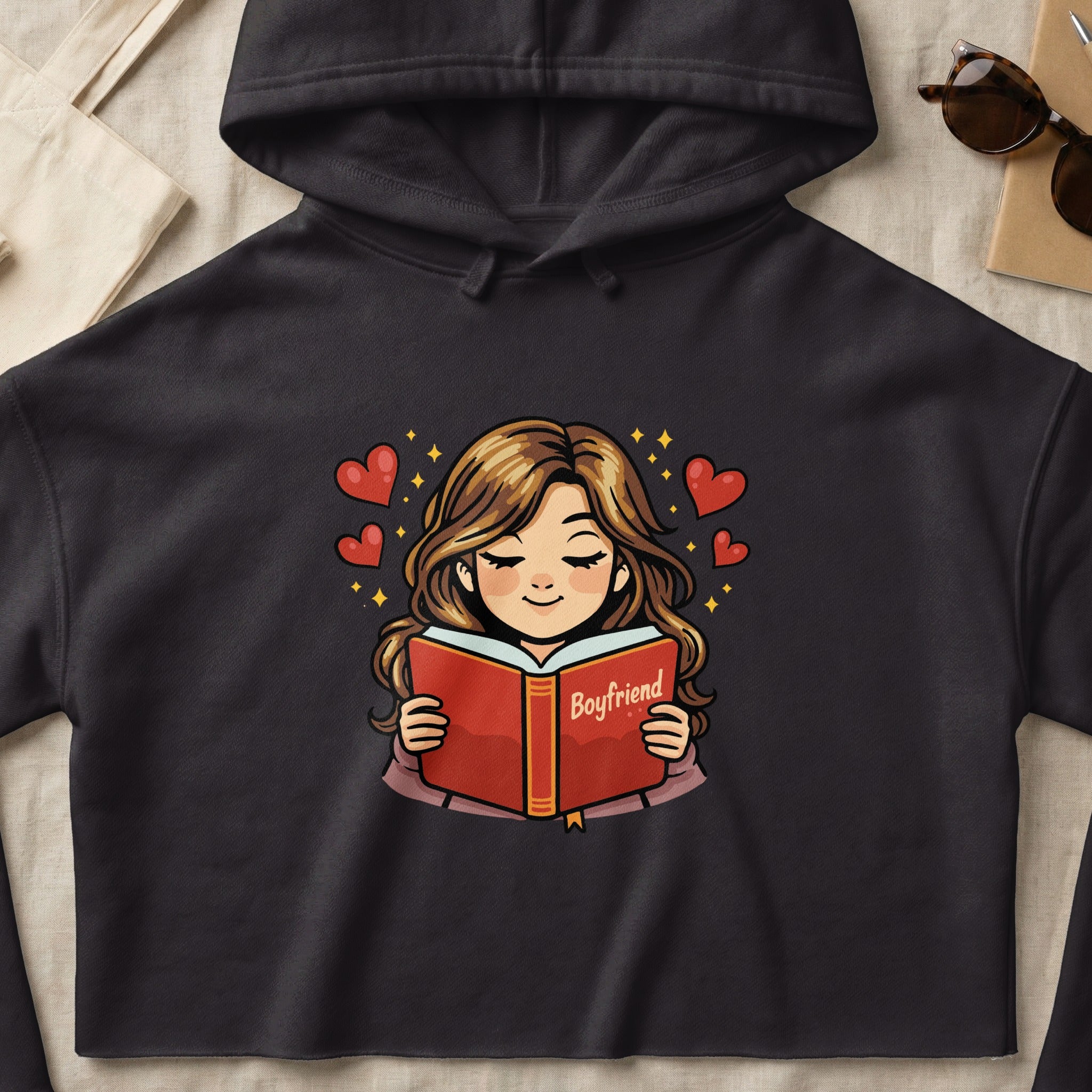 Dark grey hoodie with a cartoon of a woman reading a book titled "Boyfriend".