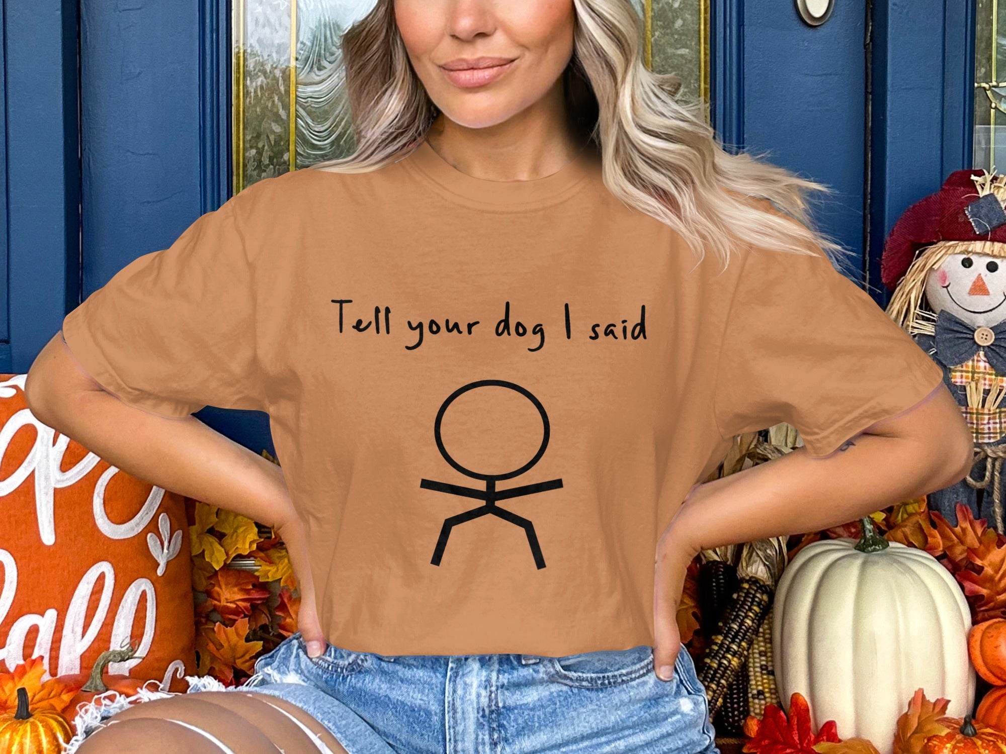 Orange t-shirt with "Tell your dog I said" and a stick figure.