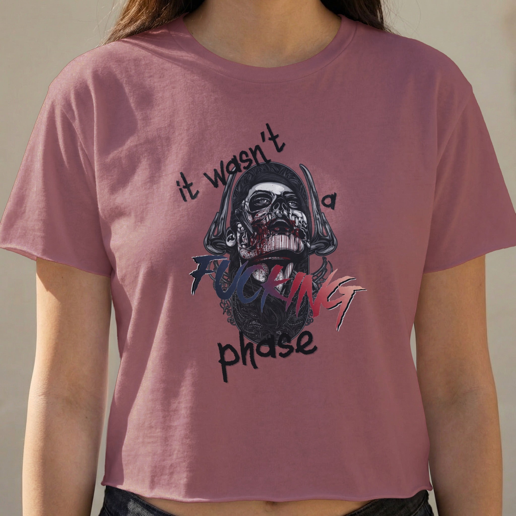 Cropped shirt with skull graphic and text "it wasn't a phase".
