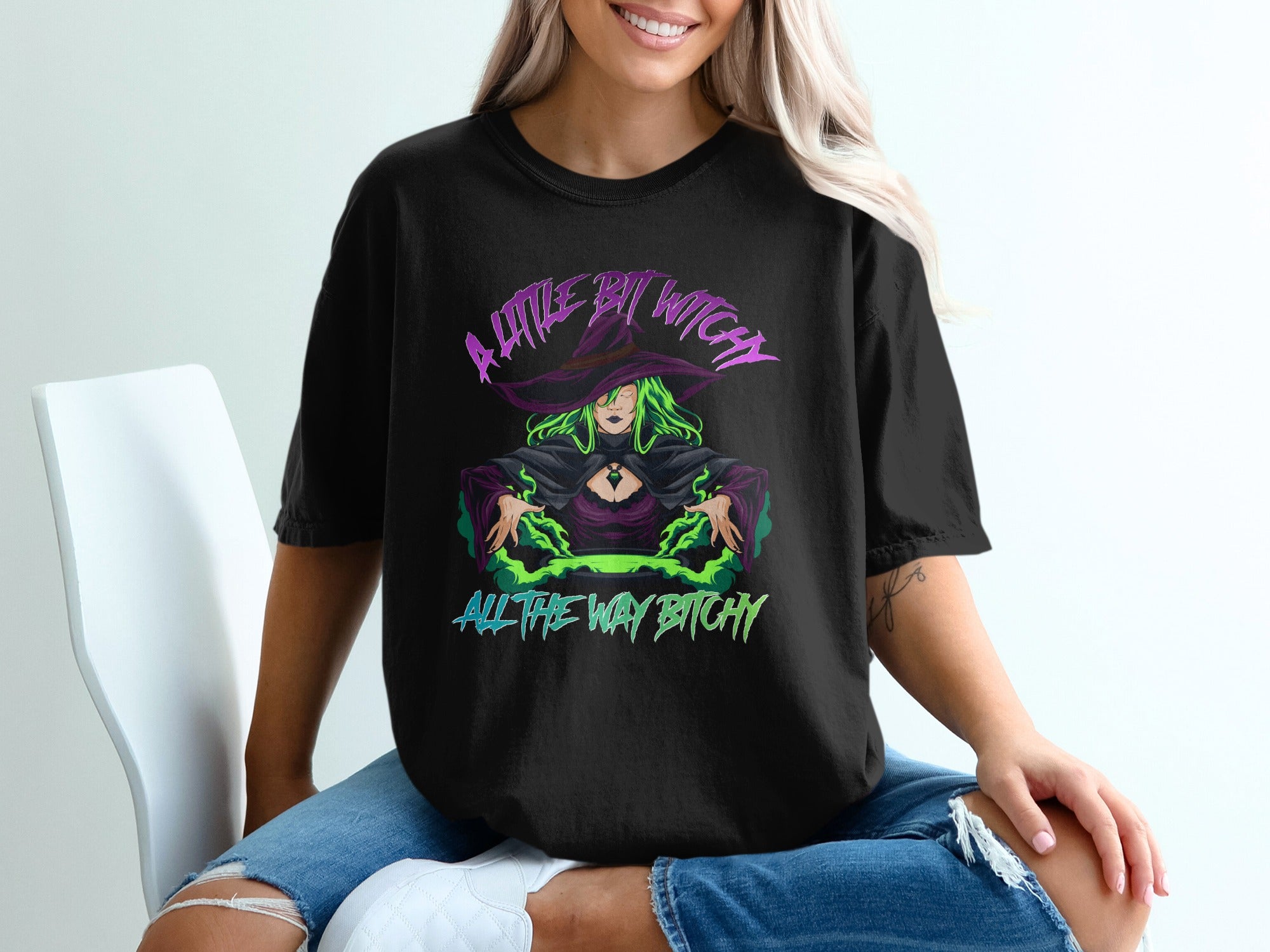 Black t-shirt with witch graphic and text "A little bit witch all the way bitchy".