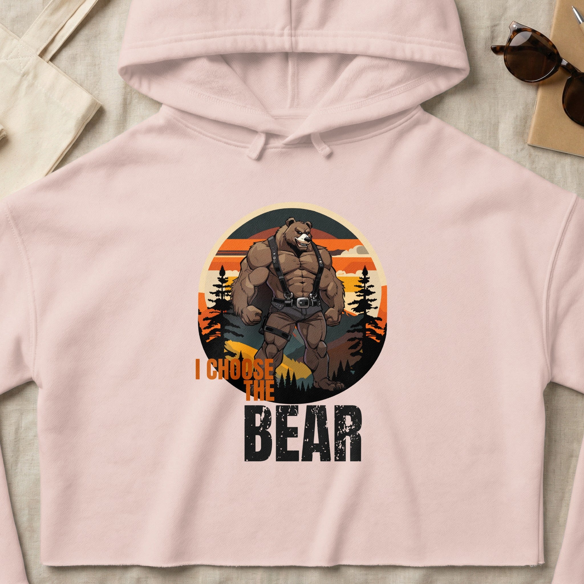Cropped pink hoodie with graphic of muscular bear and text "I CHOOSE THE BEAR".