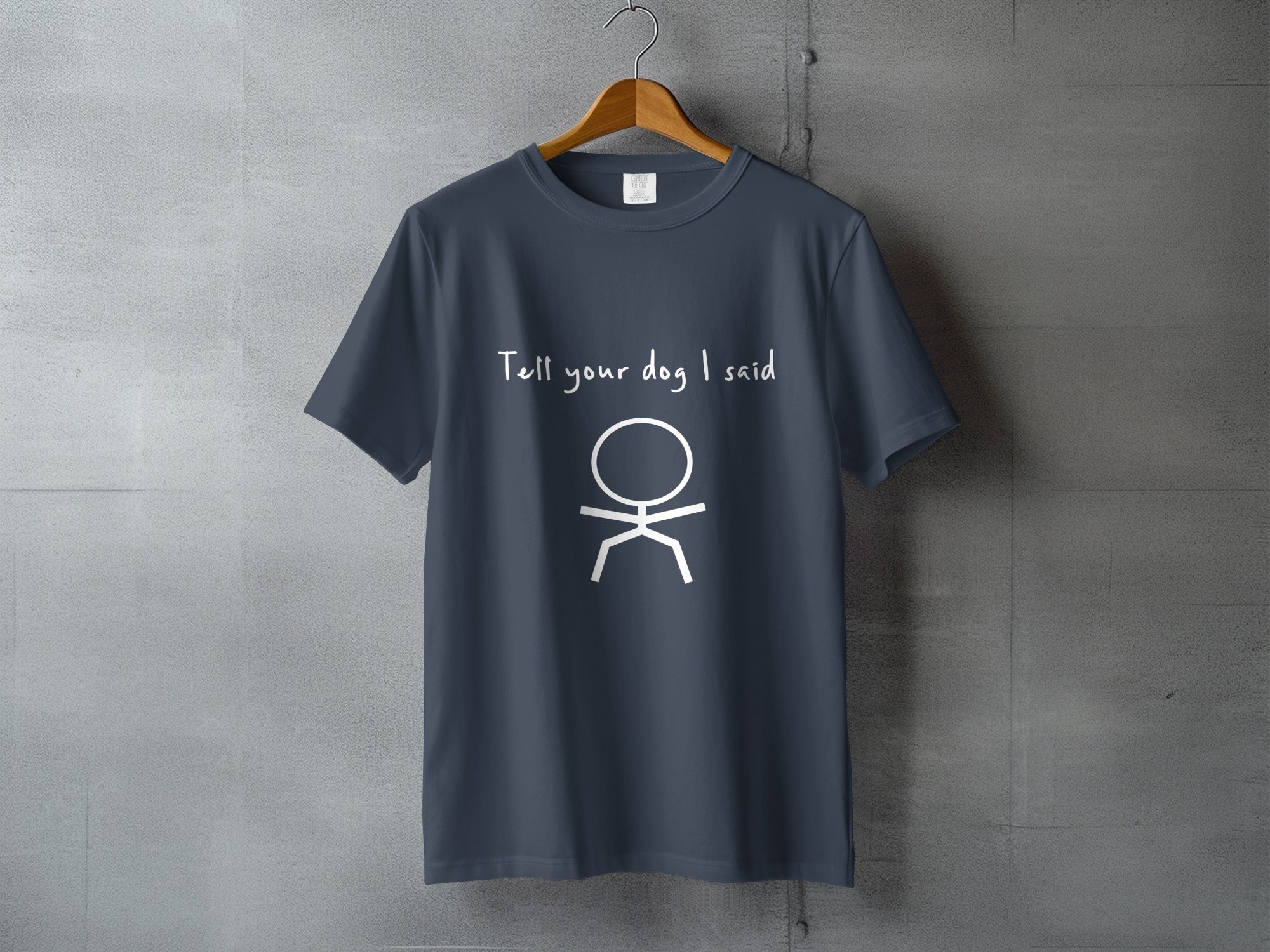 Dark blue t-shirt with "Tell your dog I said" and stick figure graphic.
