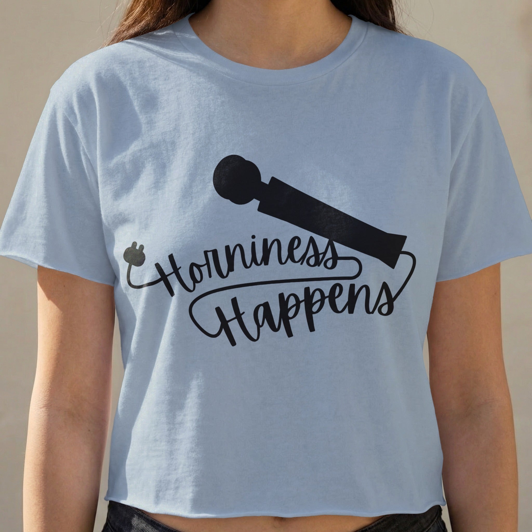 Light blue cropped t-shirt with "Horniness Happens" and a plug design.