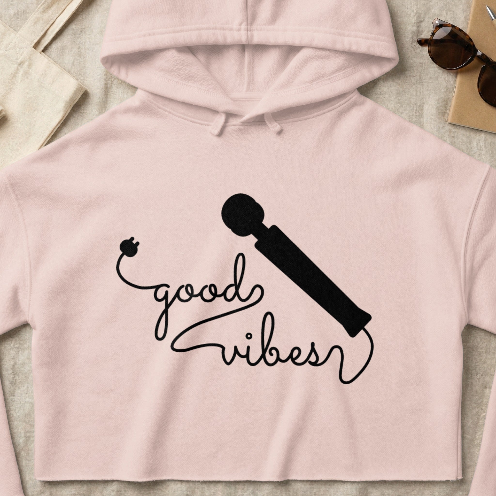 Cropped pink hoodie with "good vibes" graphic and vibrator illustration.