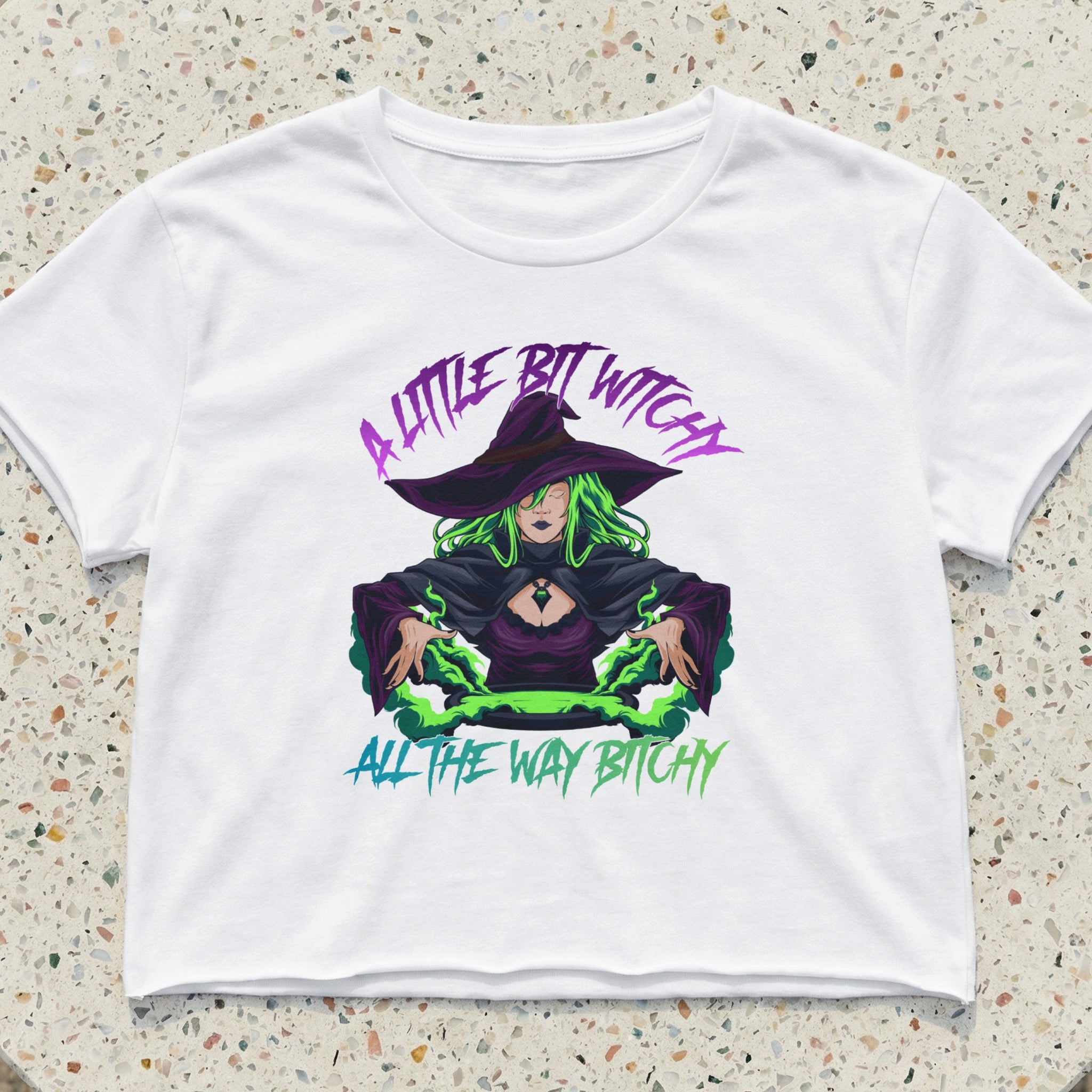 White crop top with witch graphic and text "A LITTLE BIT WITCHY ALL THE WAY BITCHY".