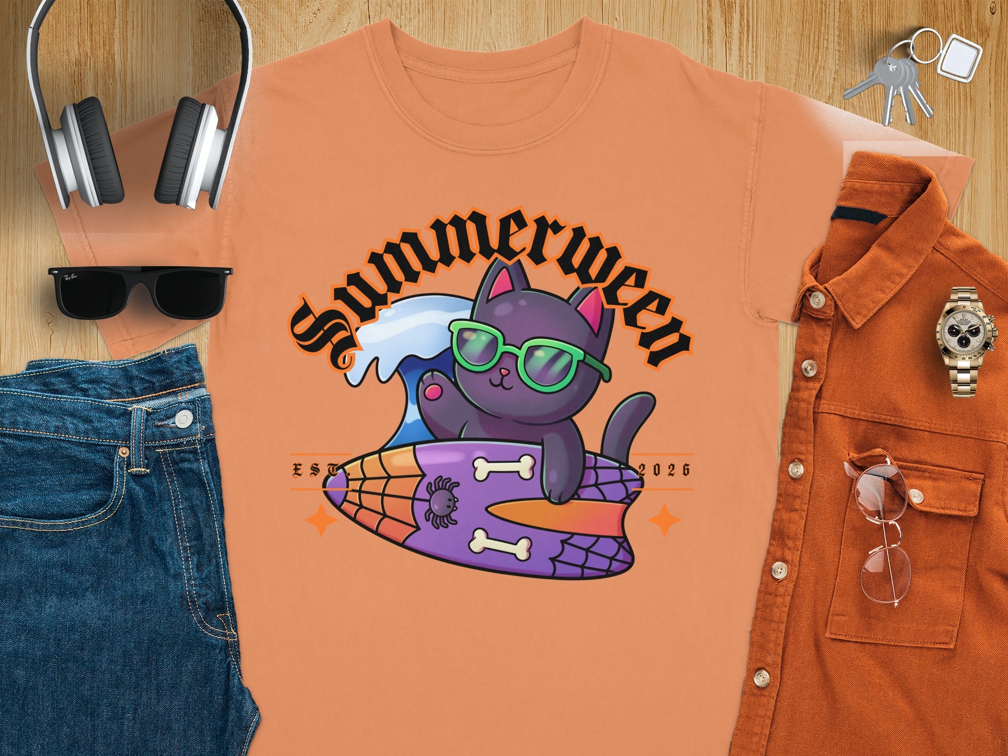 Orange t-shirt with black cat on surfboard, text "Summerween" and "EST 2026".