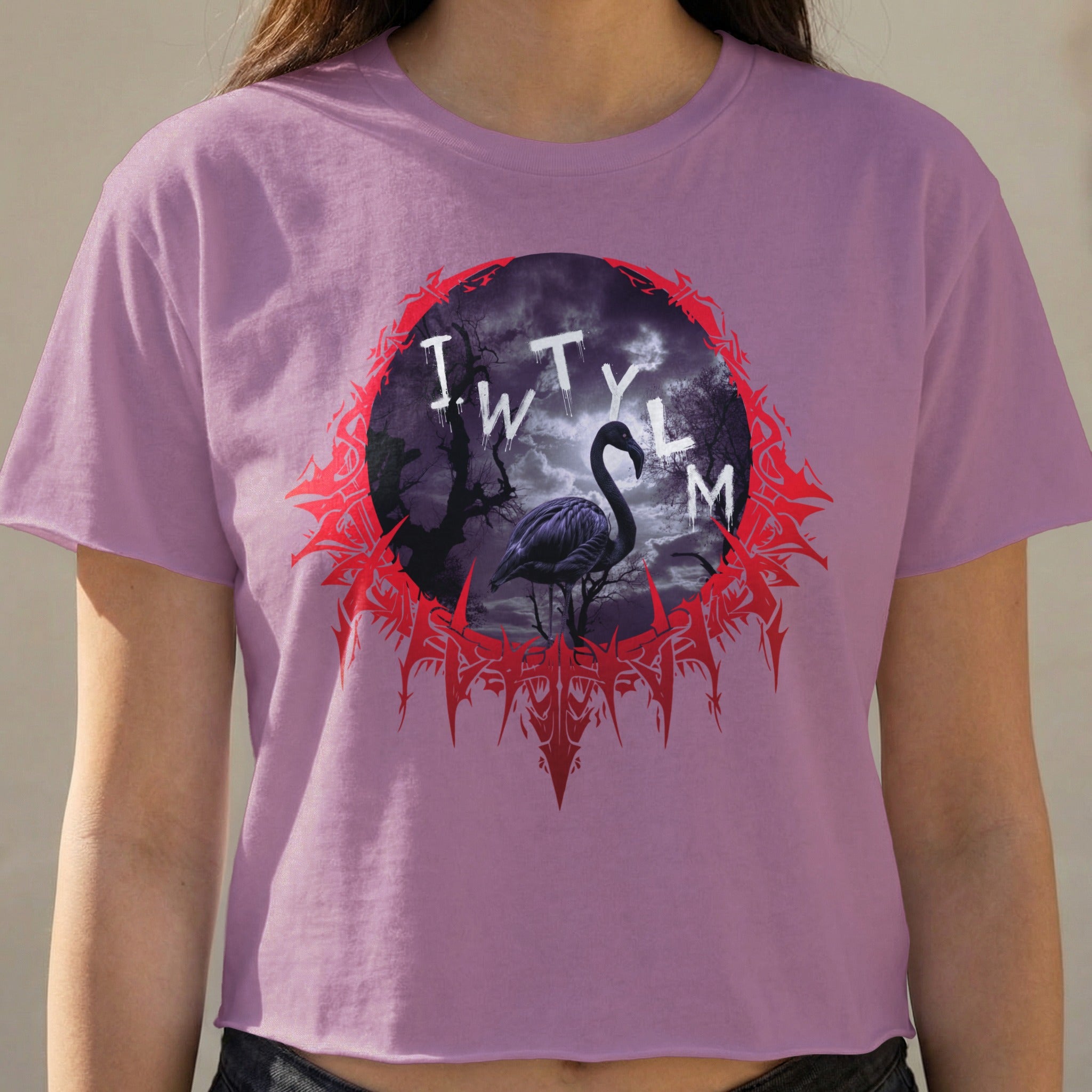 Flamingo silhouette within a circular gothic frame on a purple t-shirt.