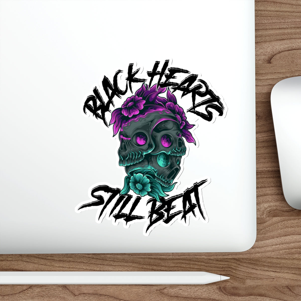 Skull wearing flowers with text "BLACK HEARTS STILL BEAT".