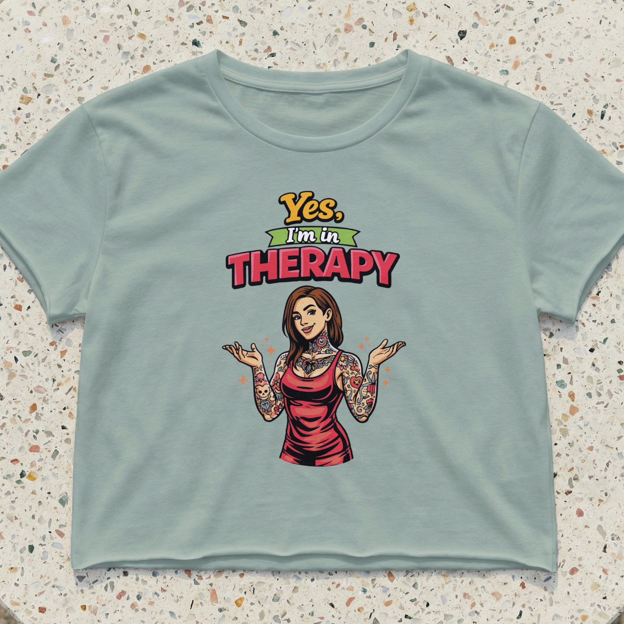 Woman with tattoos wearing a red dress and crop top, text "Yes, I'm in Therapy."