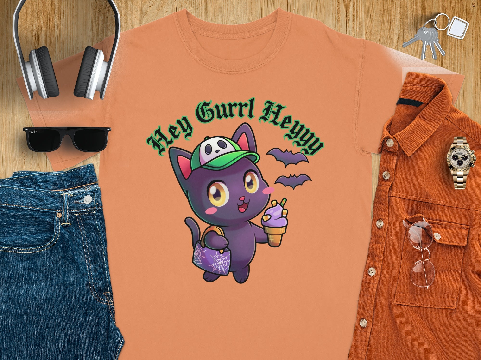 Orange t-shirt with cartoon cat, bats, and "Hey Gurrl Heyyy" text.