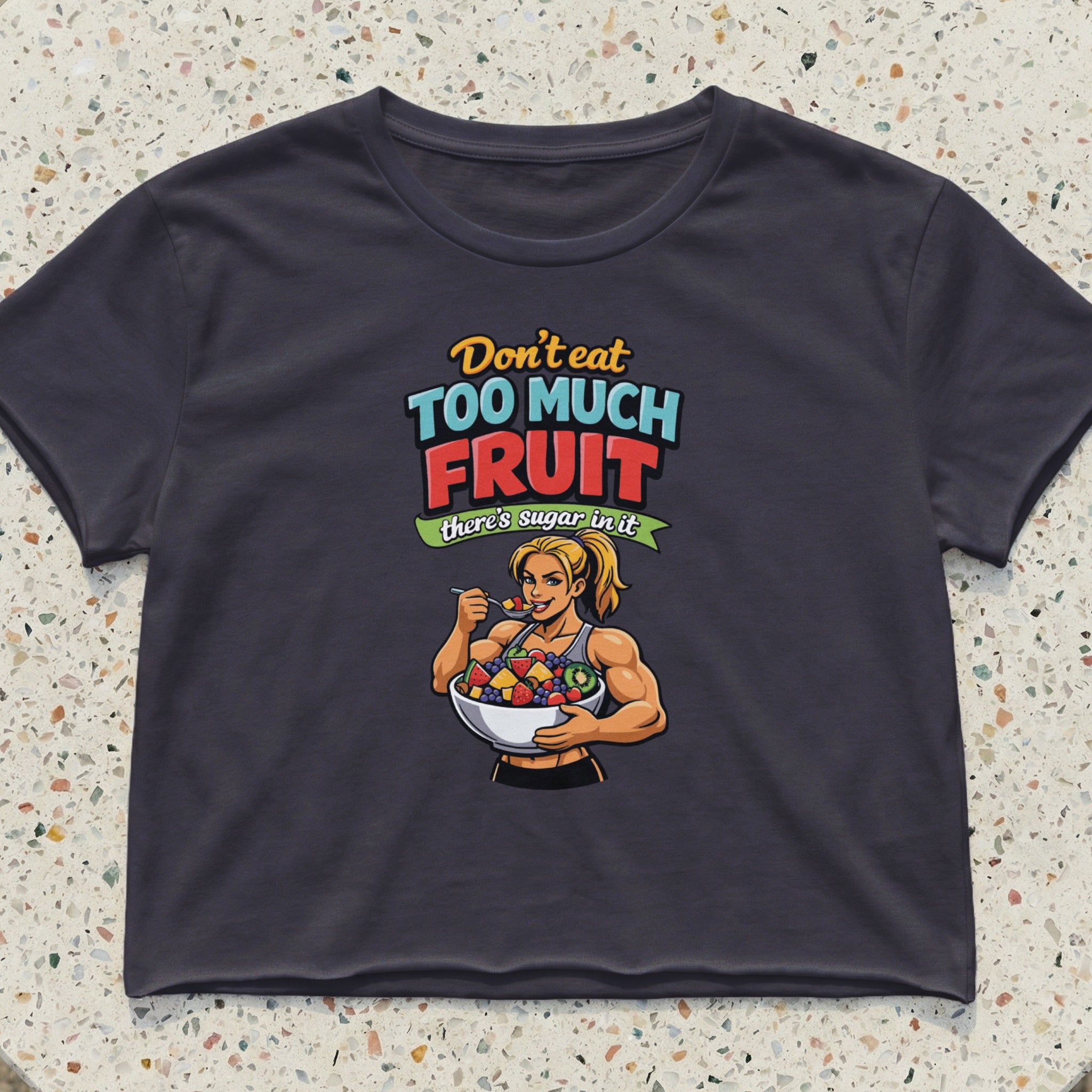 Woman in crop top eating fruit salad, text "Don't eat too much fruit, there's sugar in it".