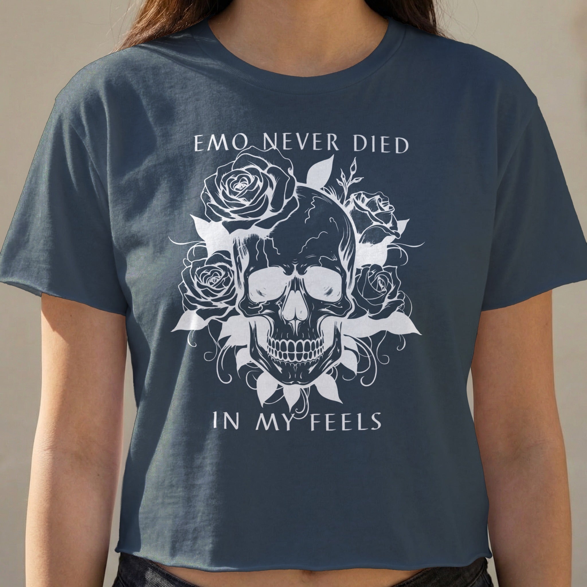Dark t-shirt with skull and roses graphic, "EMO NEVER DIED IN MY FEELS" text.