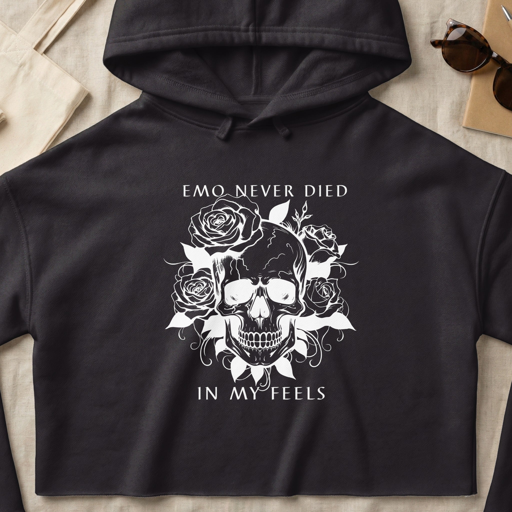 Black hoodie with white skull, roses, and text "EMO NEVER DIED IN MY FEELS".
