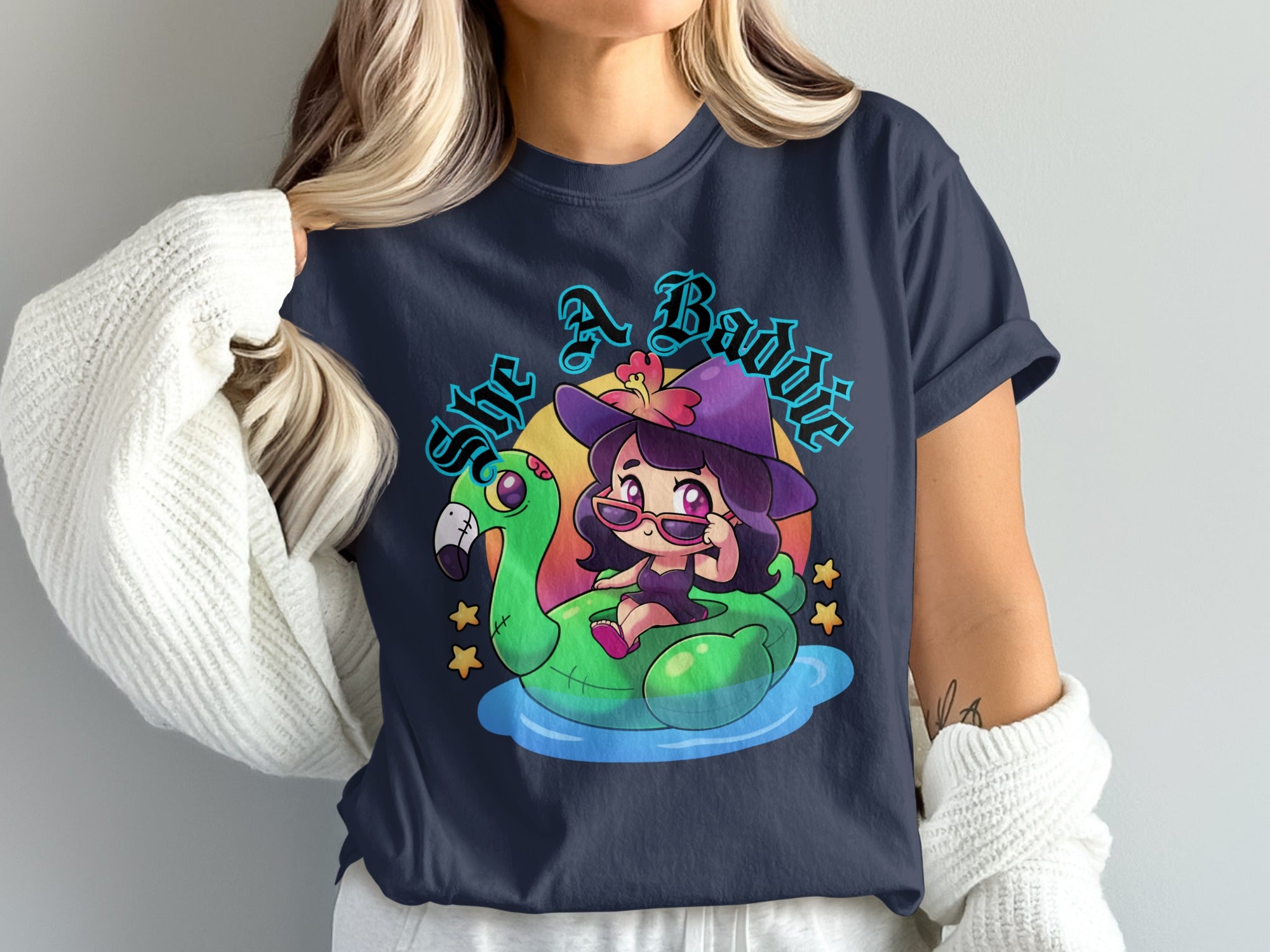 Cartoon witch on flamingo float with text "She A Baddie"