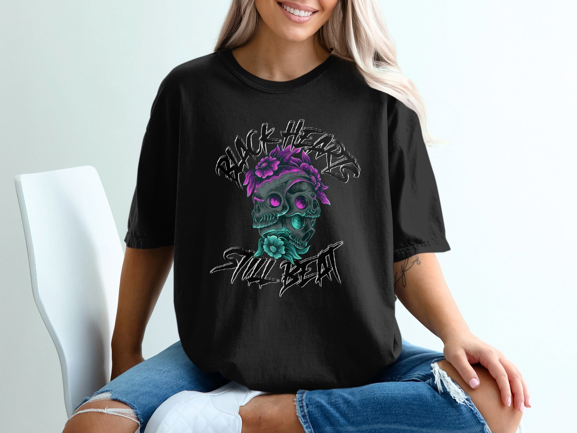Black t-shirt with skull graphic featuring flowers and "Skull Beat" text.