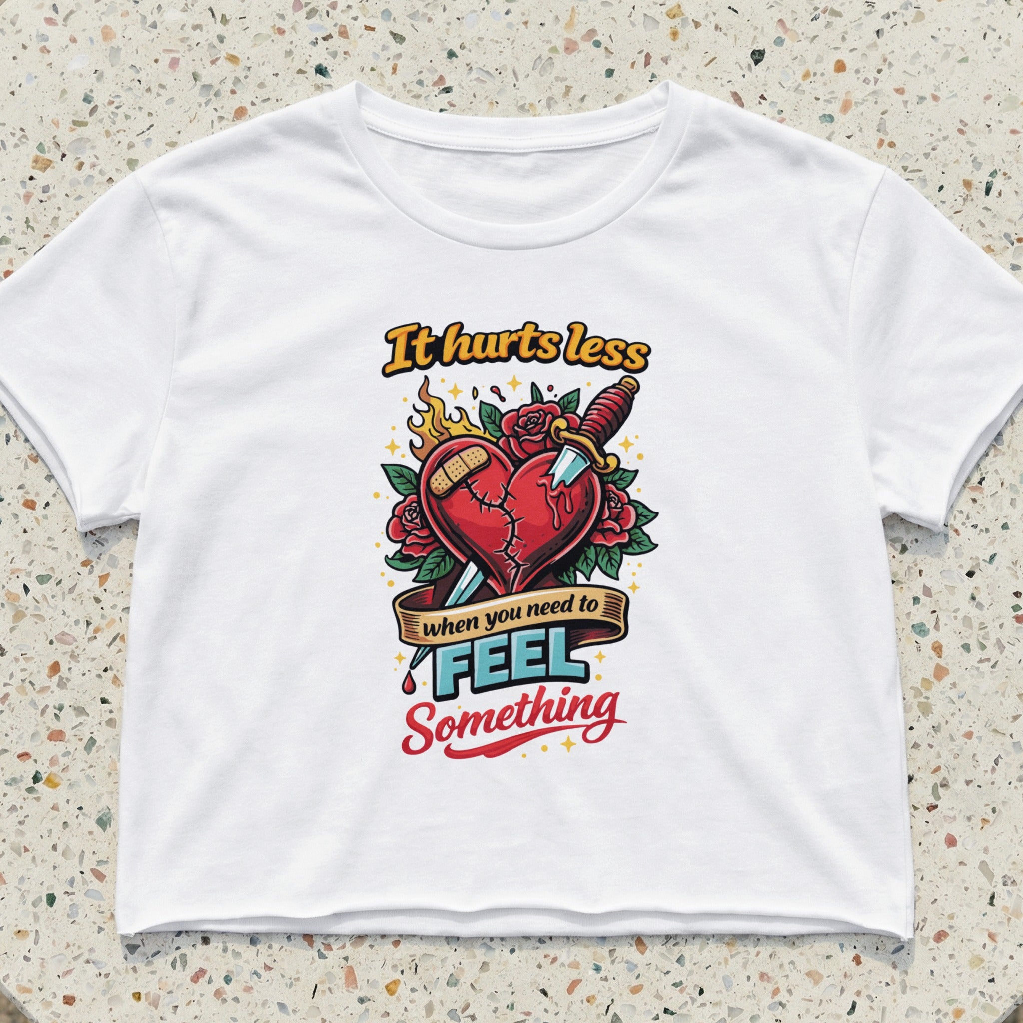 White t-shirt with colorful graphic of a broken heart, knife, and flames.