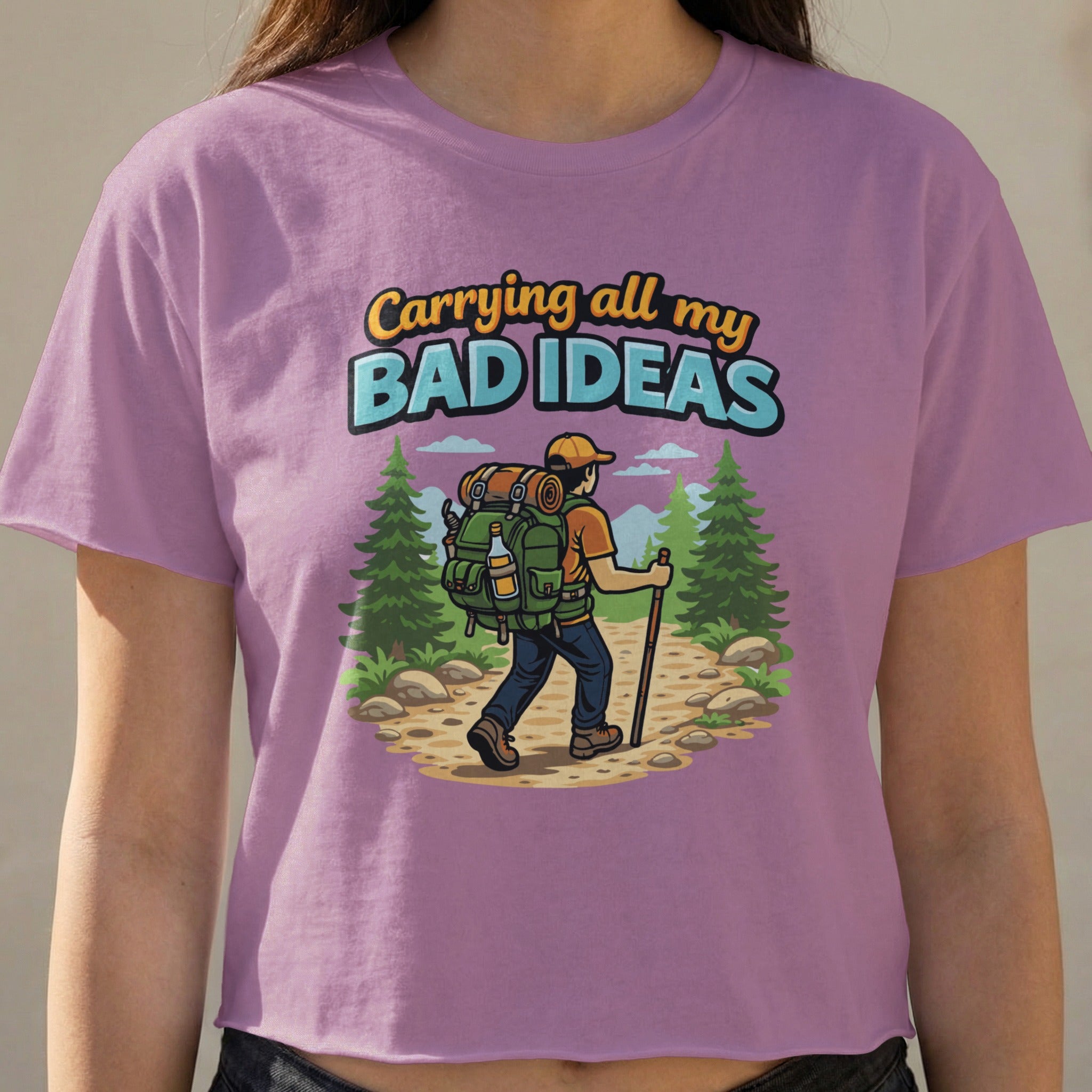 Purple t-shirt with "Carrying all my Bad Ideas" text and a hiker illustration.