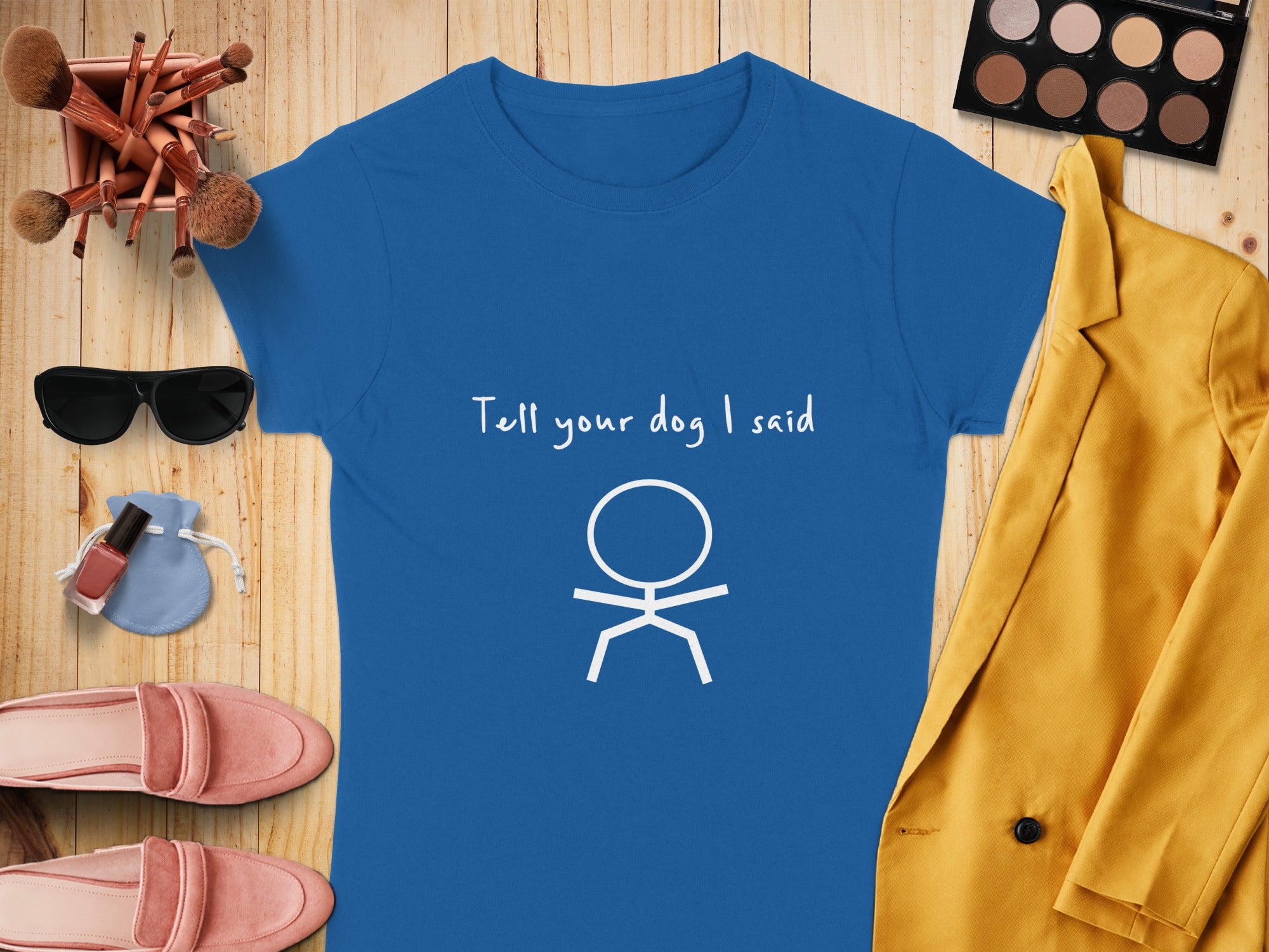 Blue t-shirt with "Tell your dog I said" and stick figure graphic.