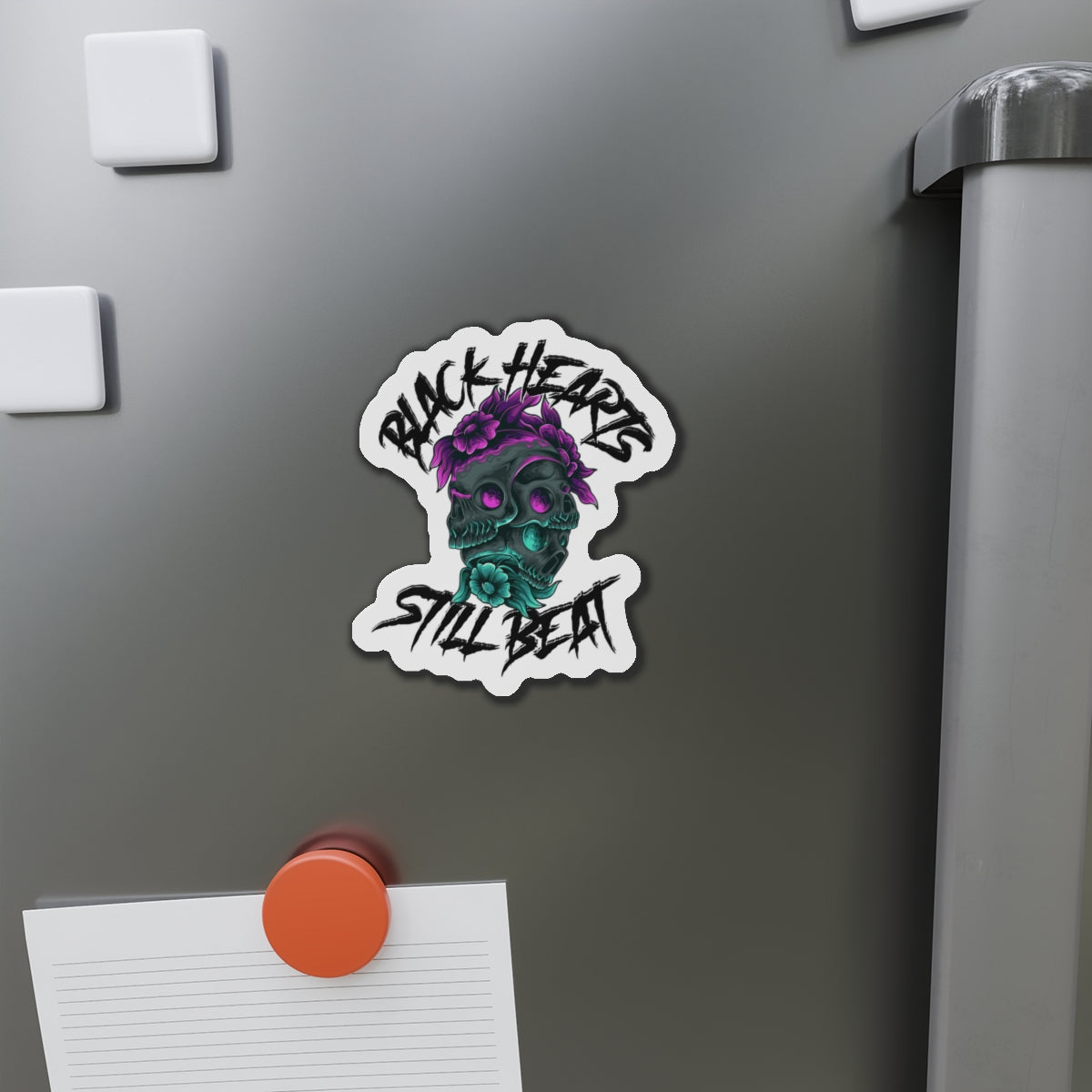 Black Hearts Still Beat skull sticker with floral accents.