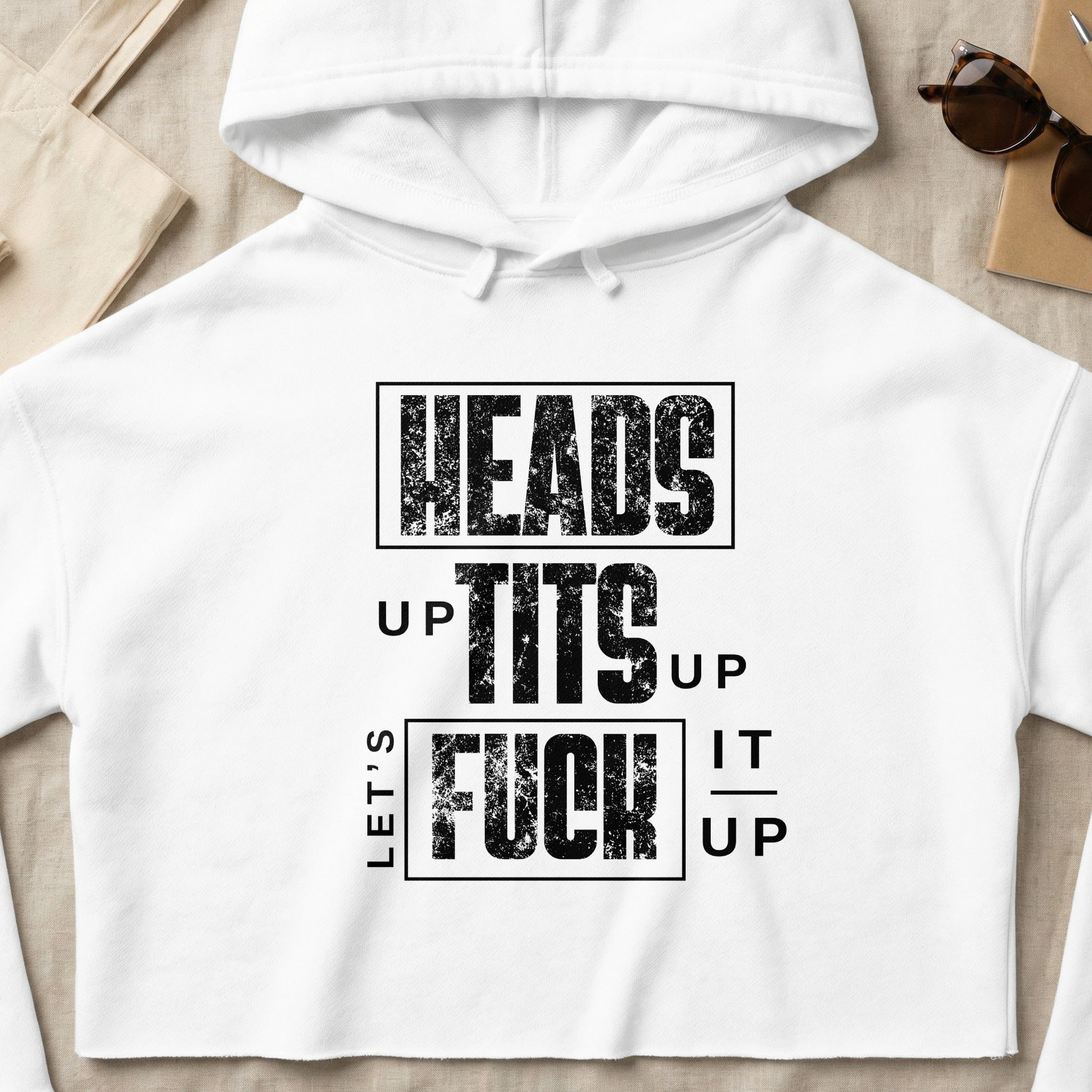 White cropped hoodie with "LET'S GET HEADS UP TITS UP FUCK IT UP" text.