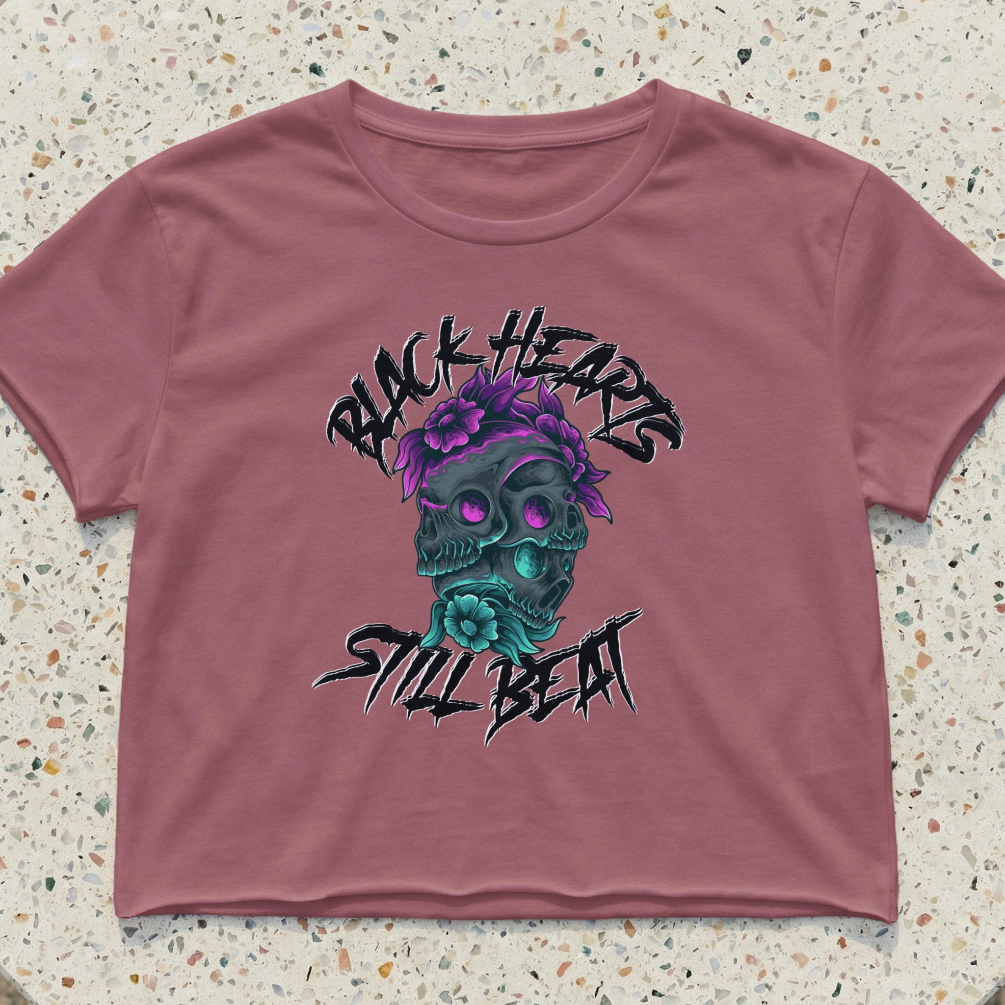 Pink crop top with black hearts and skull graphic, "Still Beat" text.