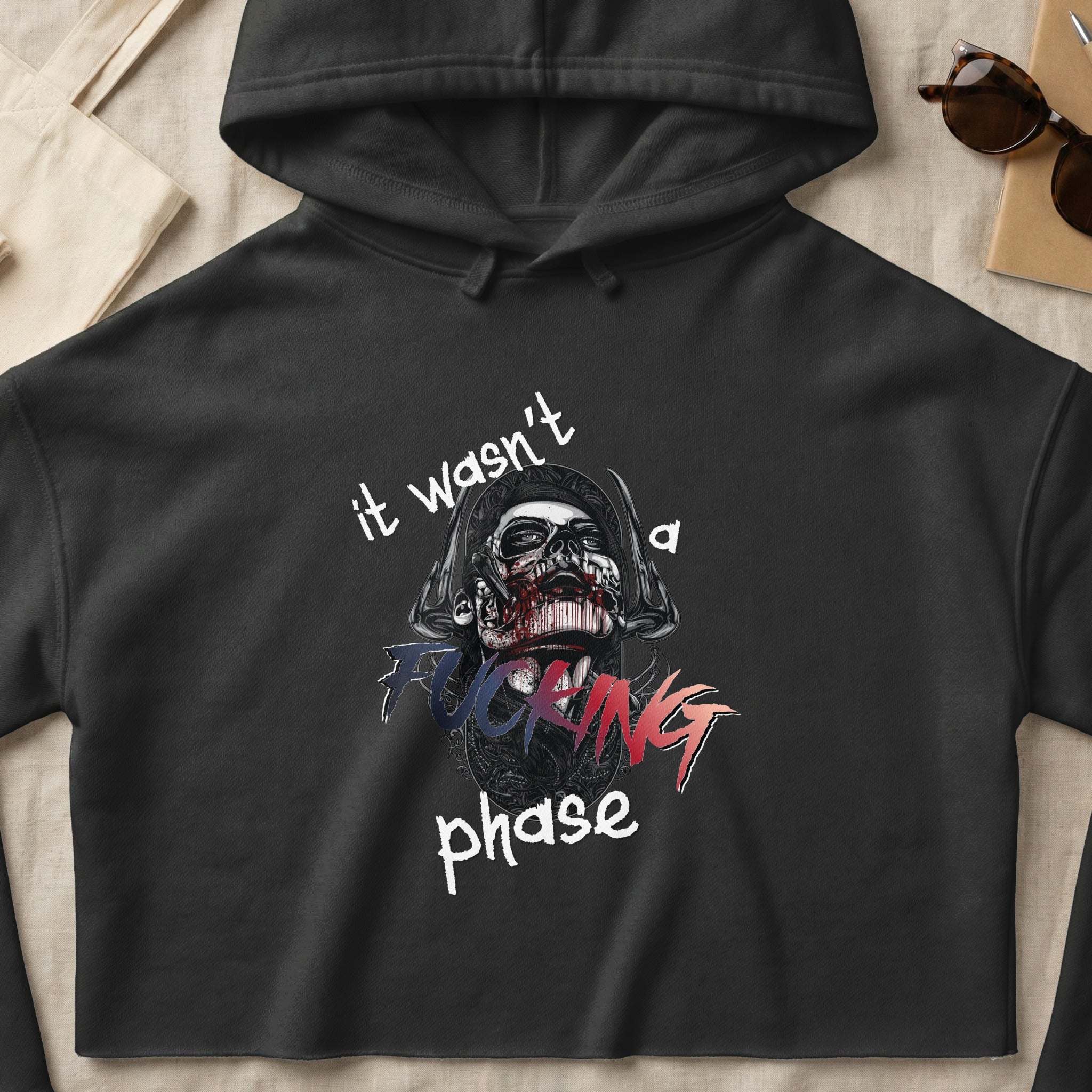 Black hoodie with graphic of a zombie head and text "it wasn't a FUCKING phase".