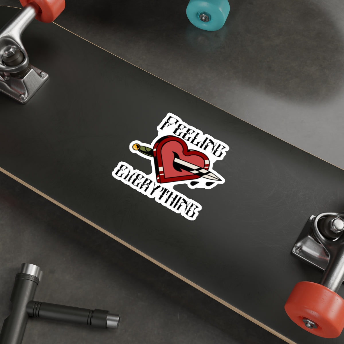 Heart pierced by dagger sticker with "FEELING EVERYTHING" text.