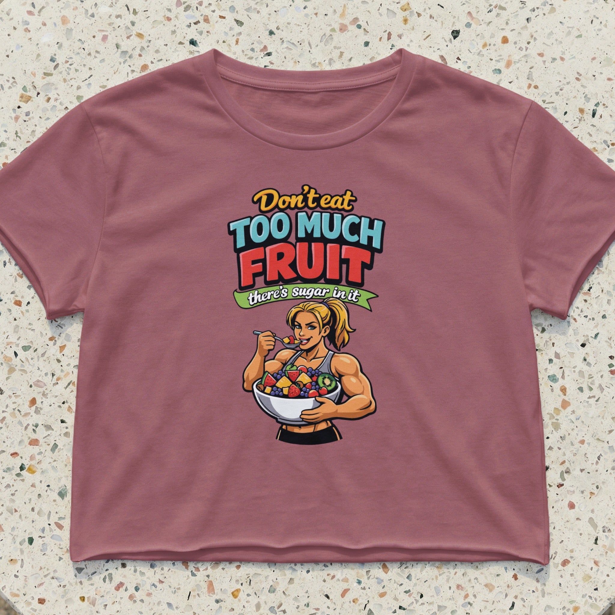 Crop top with text and illustration of a woman eating fruit salad.