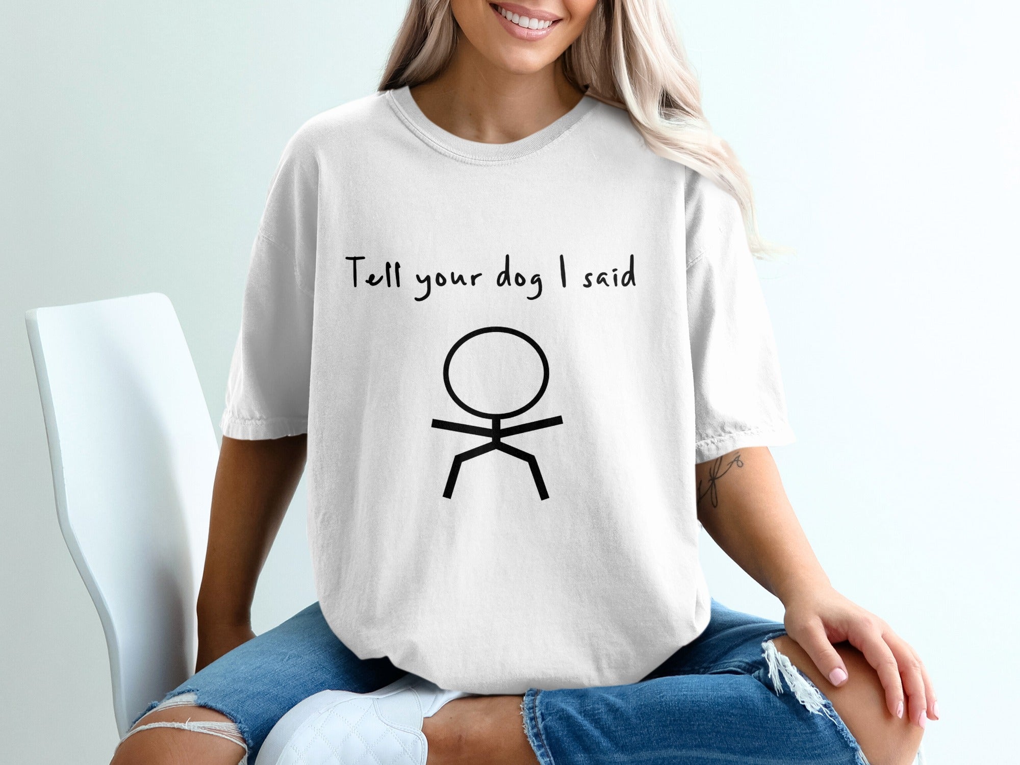 White t-shirt with black stick figure and "Tell your dog I said" text.