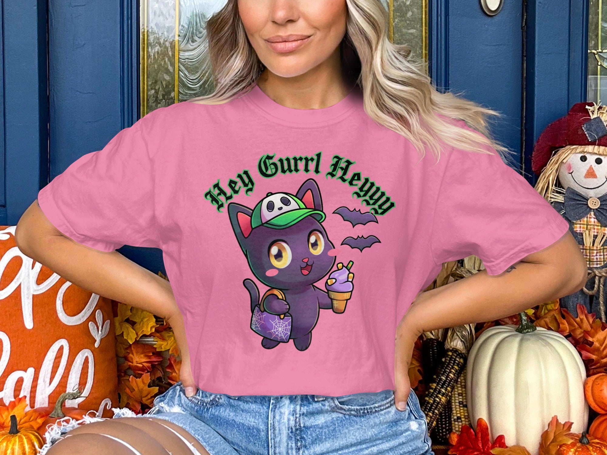 Pink t-shirt with cartoon black cat wearing a green hat, holding ice cream, and text "Hey Gurrl Heyyy".