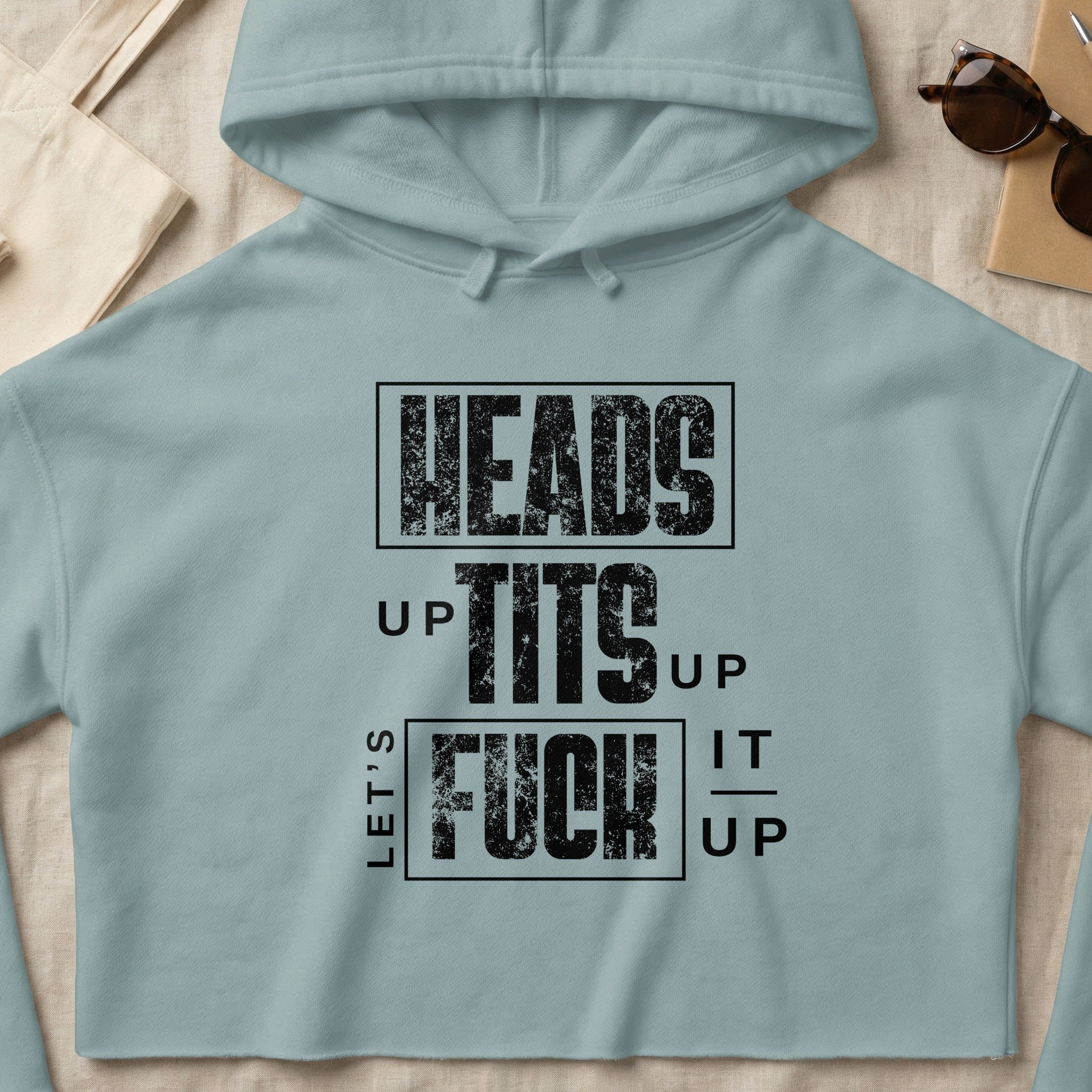 Light blue cropped hoodie with "Heads Up Tits Up Let's Fuck It Up" text.