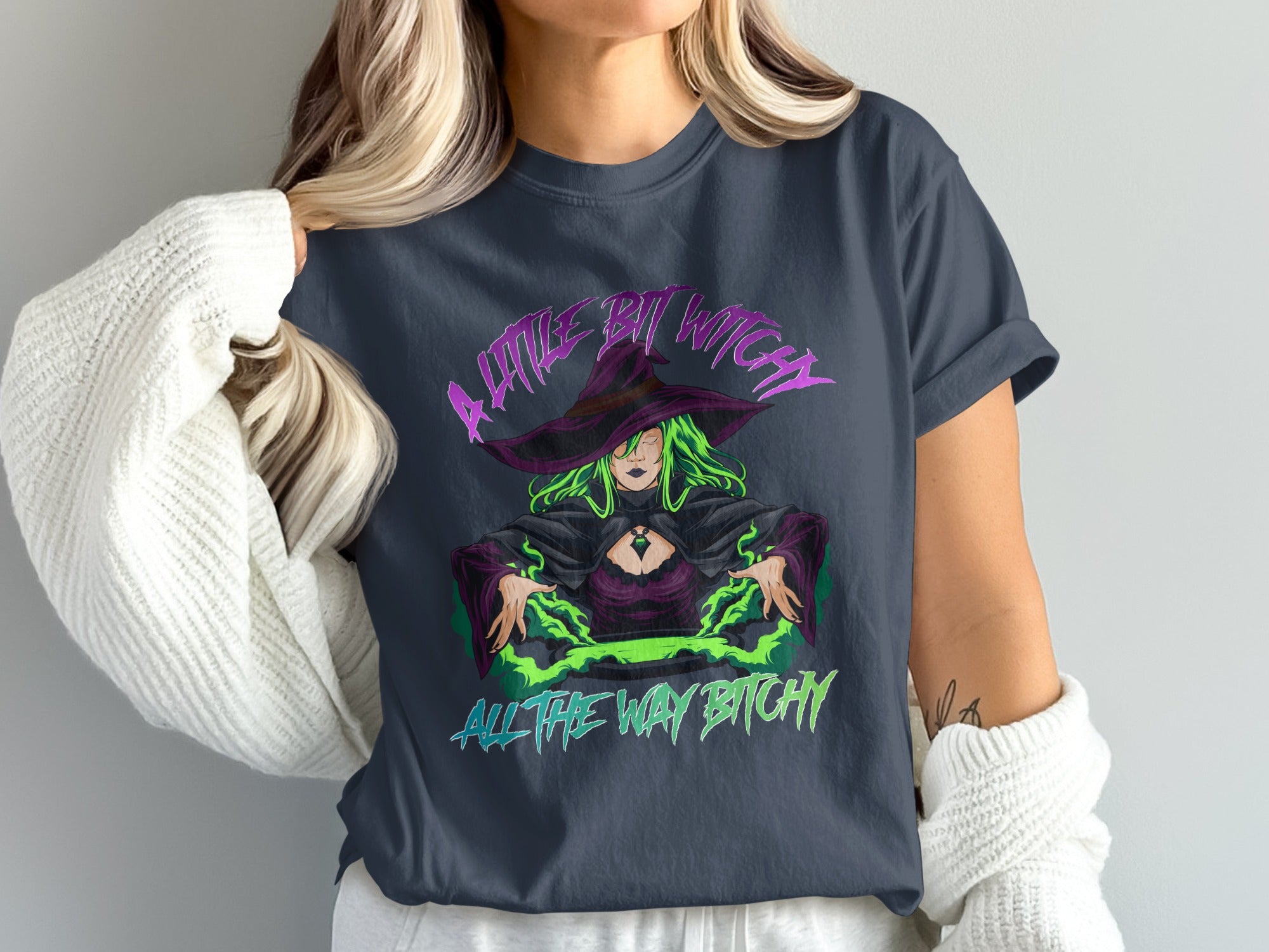 Dark t-shirt with witch graphic and text "A little bit witchy all the way bitchy".