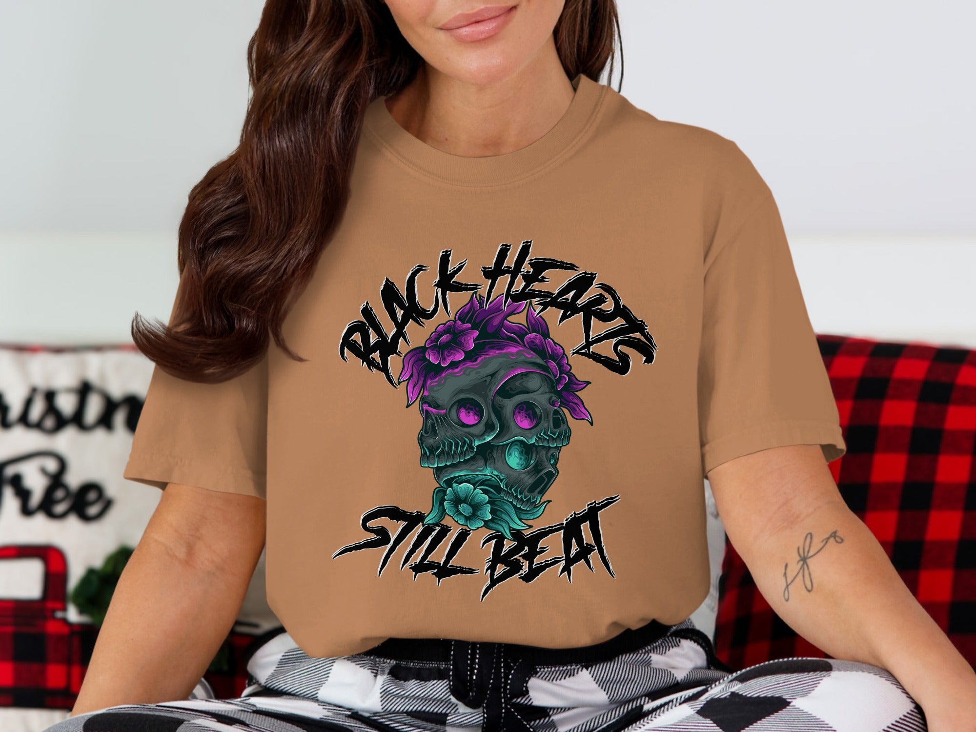 T-shirt with black skull, flowers, and "BLACK HEARTS STILL BEAT" text.