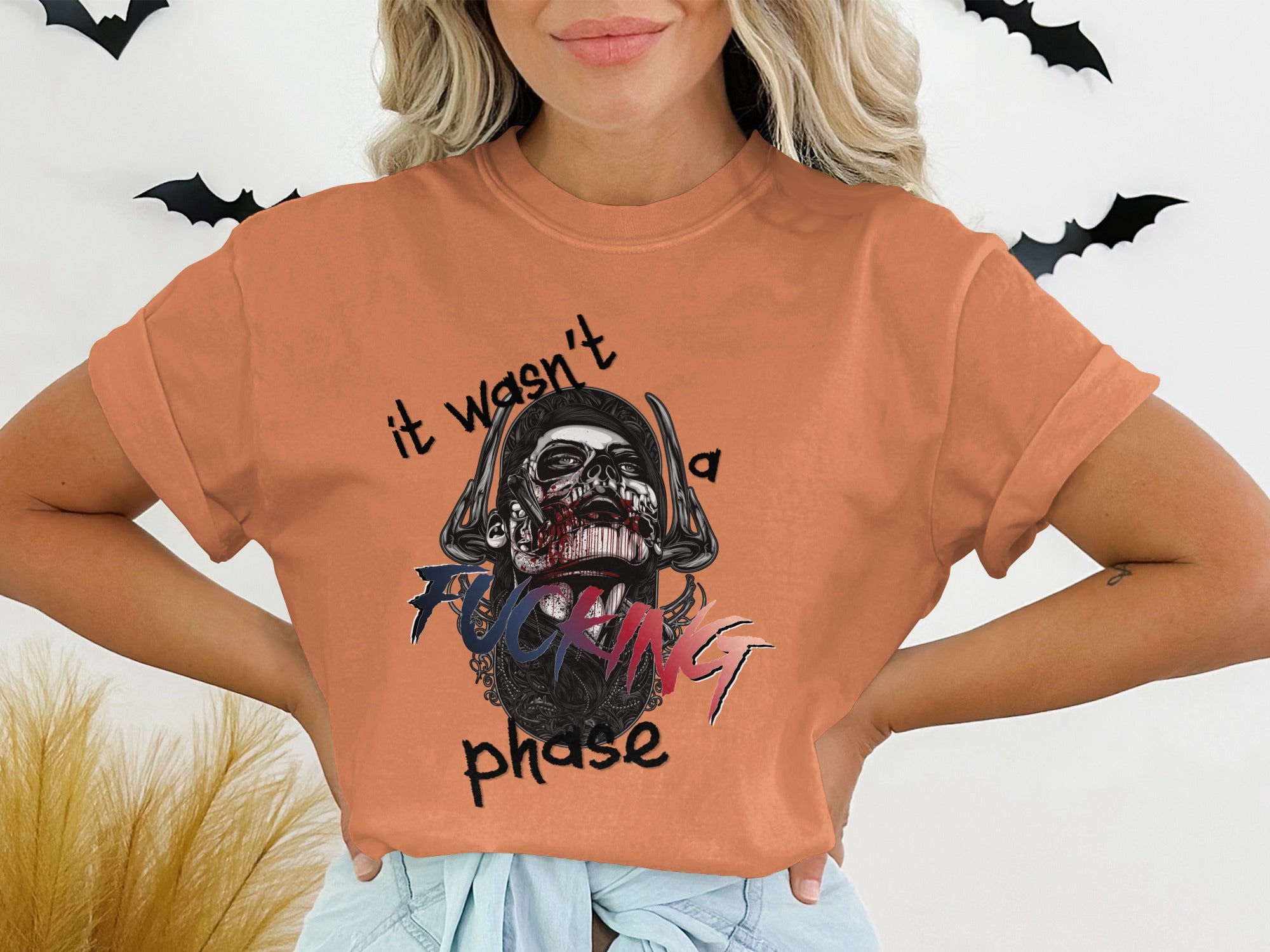 Orange t-shirt with skull graphic and text "it wasn't a fucking phase".