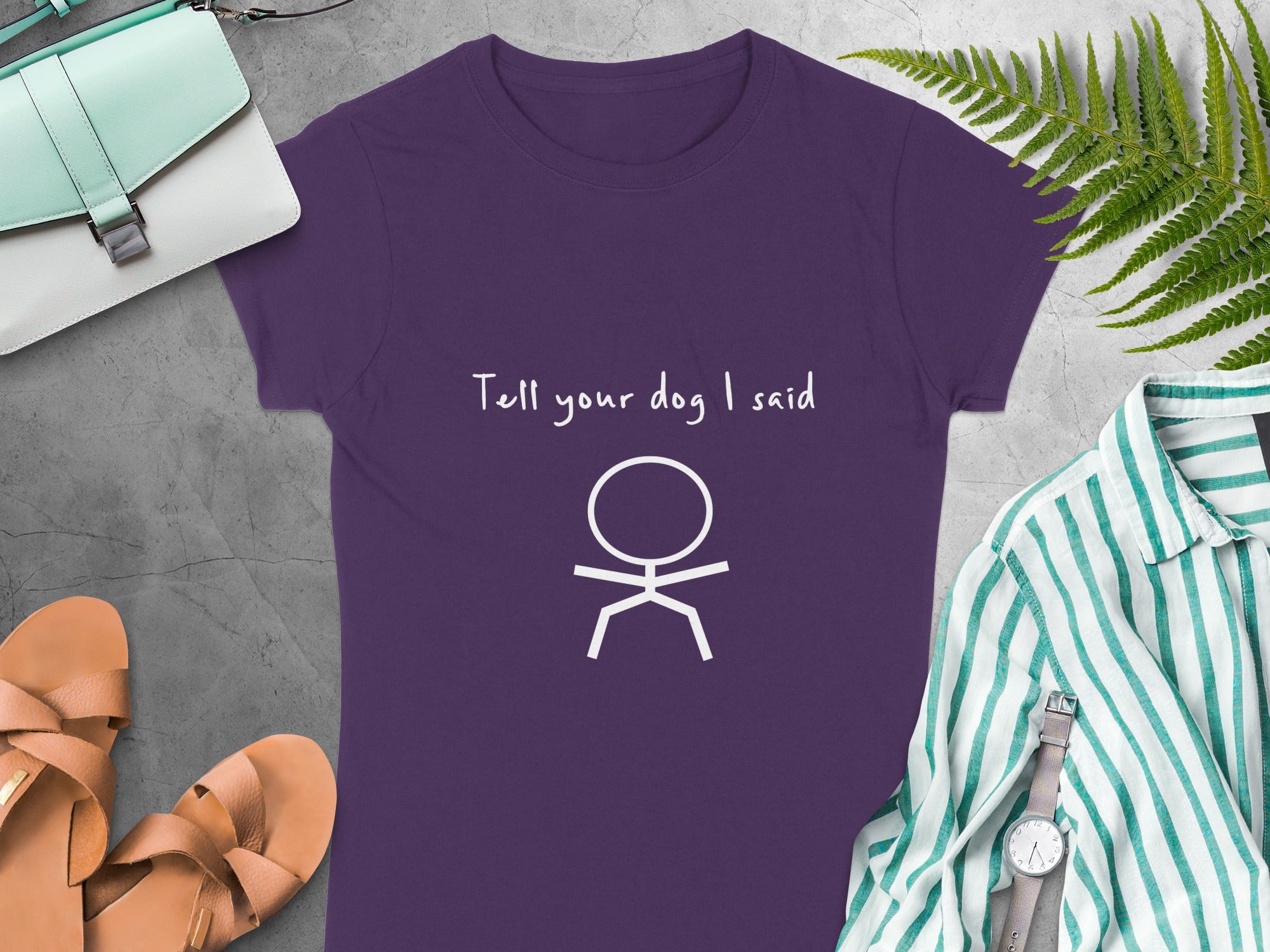Purple t-shirt with white stick figure and "Tell your dog I said" text.