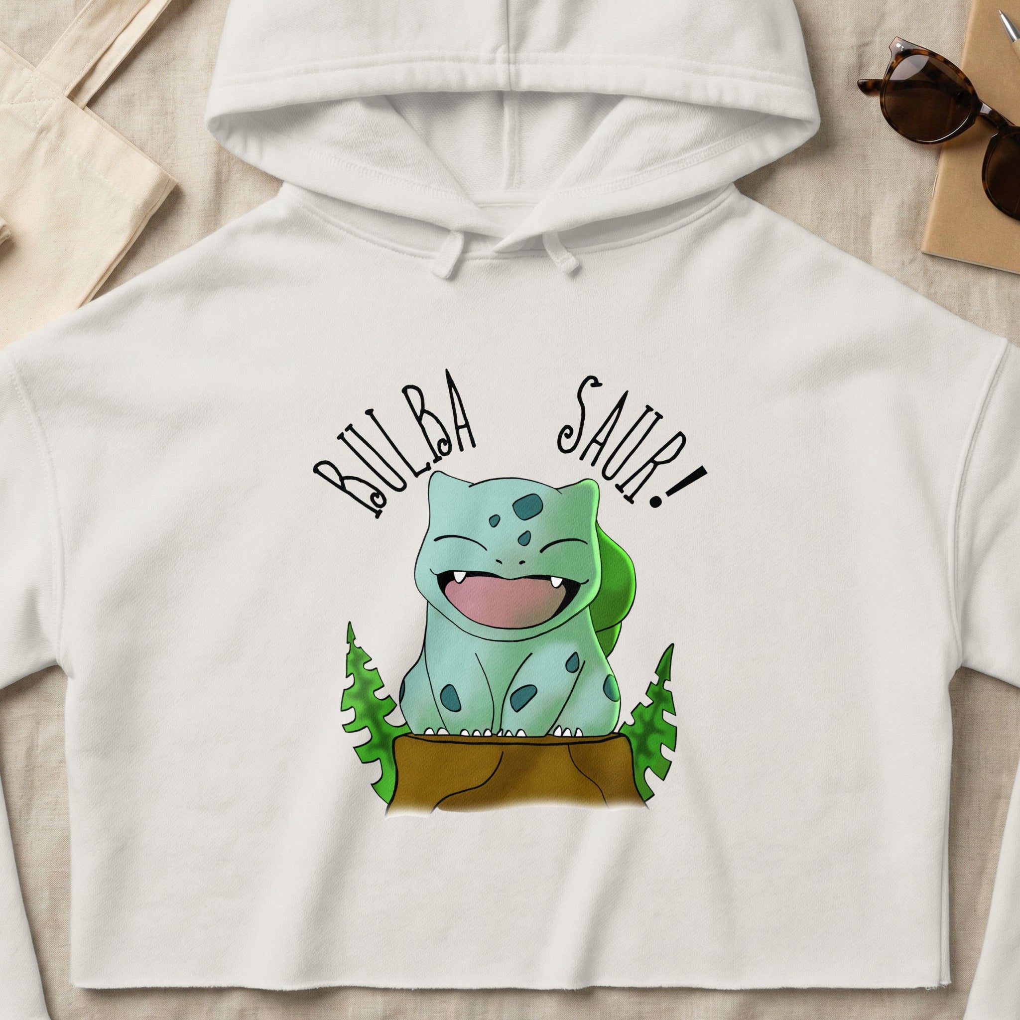 Bulbasaur with "Bulbasaur!" text on a white cropped hoodie.