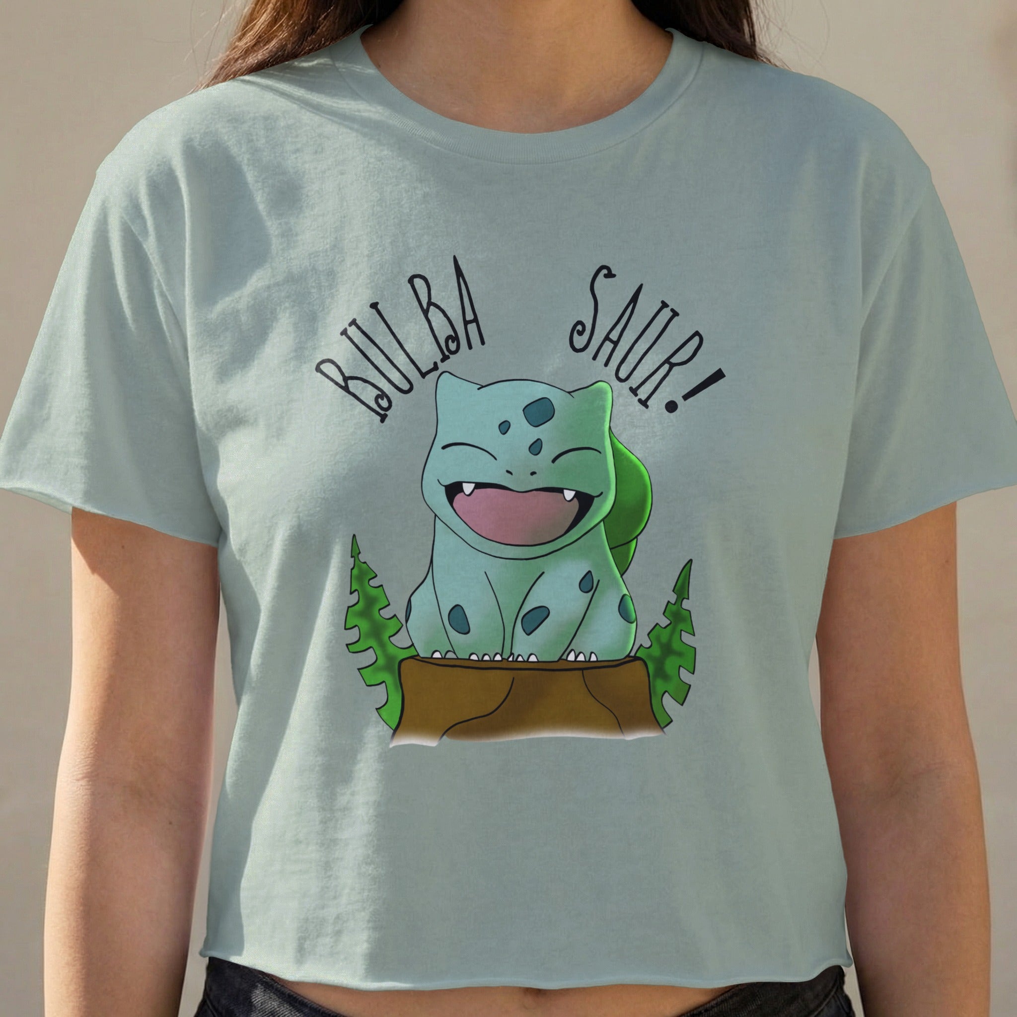 Bulbasaur character from Pokemon on a light blue crop top.