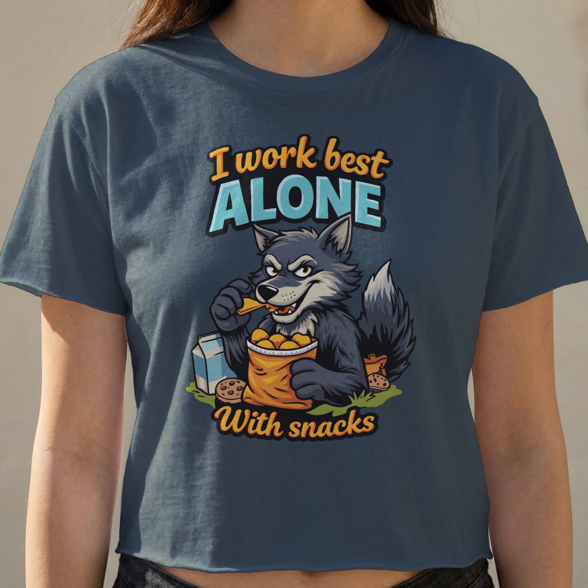 Wolf in a t-shirt that reads "I work best alone with snacks."