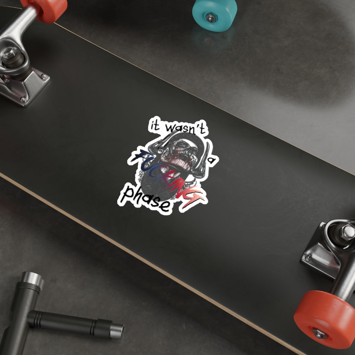 Sticker of a skull wearing a helmet with "it wasn't a phase" text.