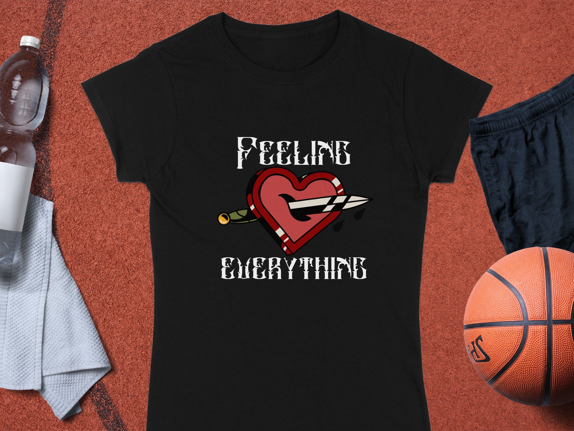 Black t-shirt with "Feeling Everything" text and heart with sword graphic.