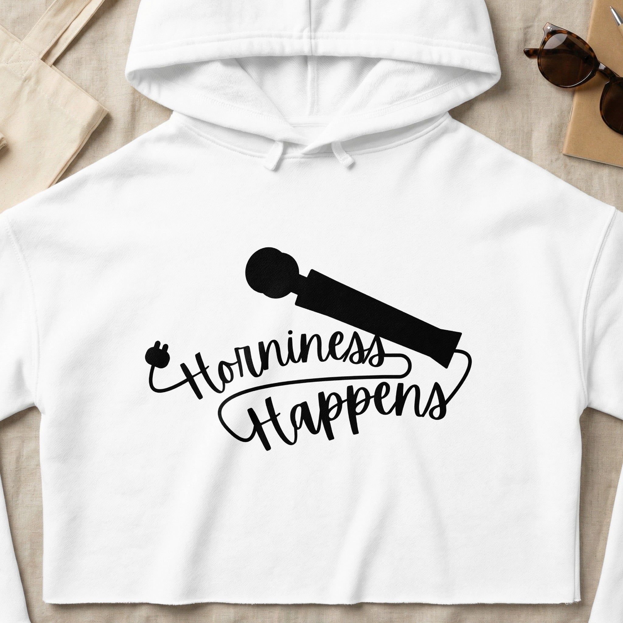 White cropped hoodie with "Horniness Happens" text and vibrator graphic.