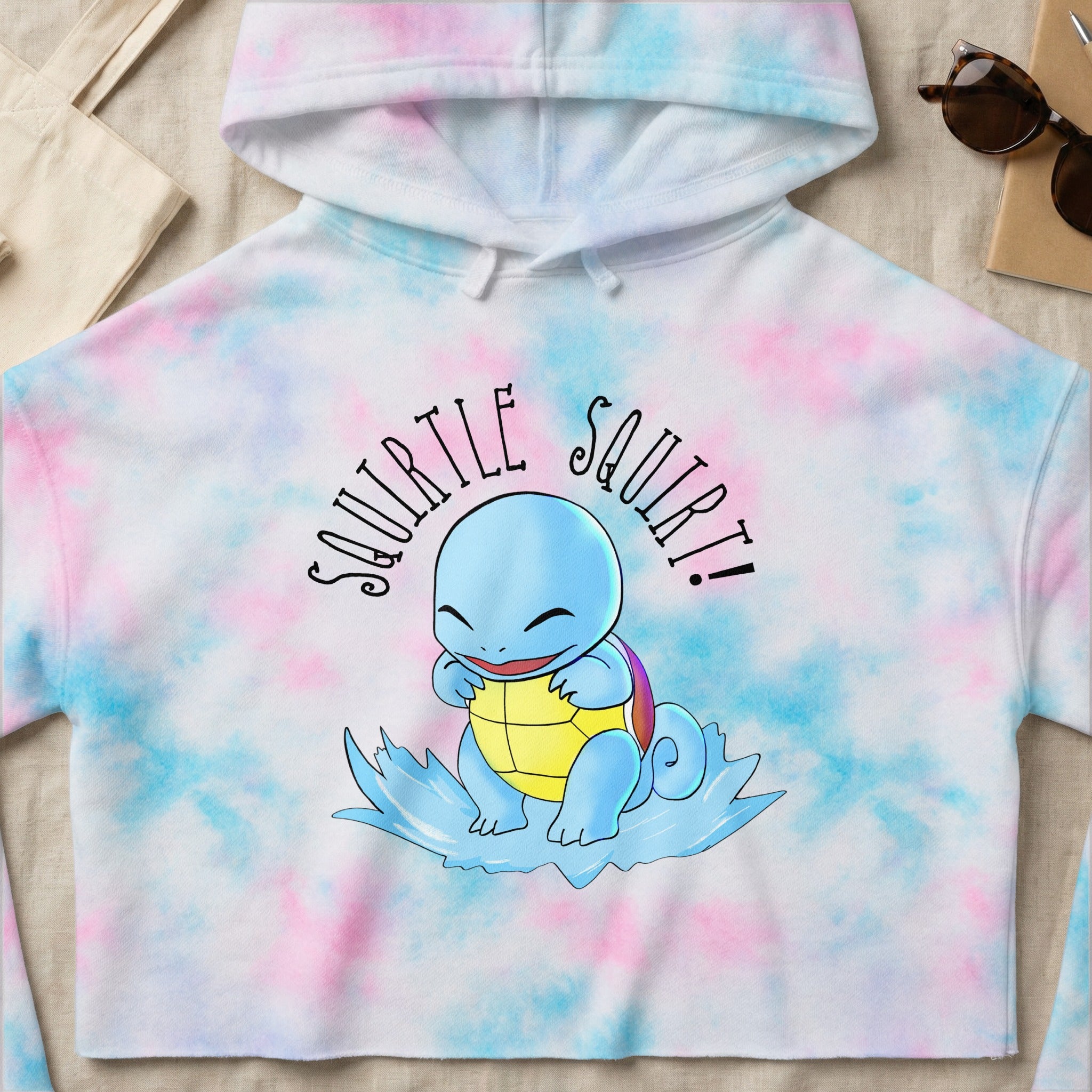 Squirtle graphic on tie-dye crop hoodie with "Squirtle Squirt!" text.