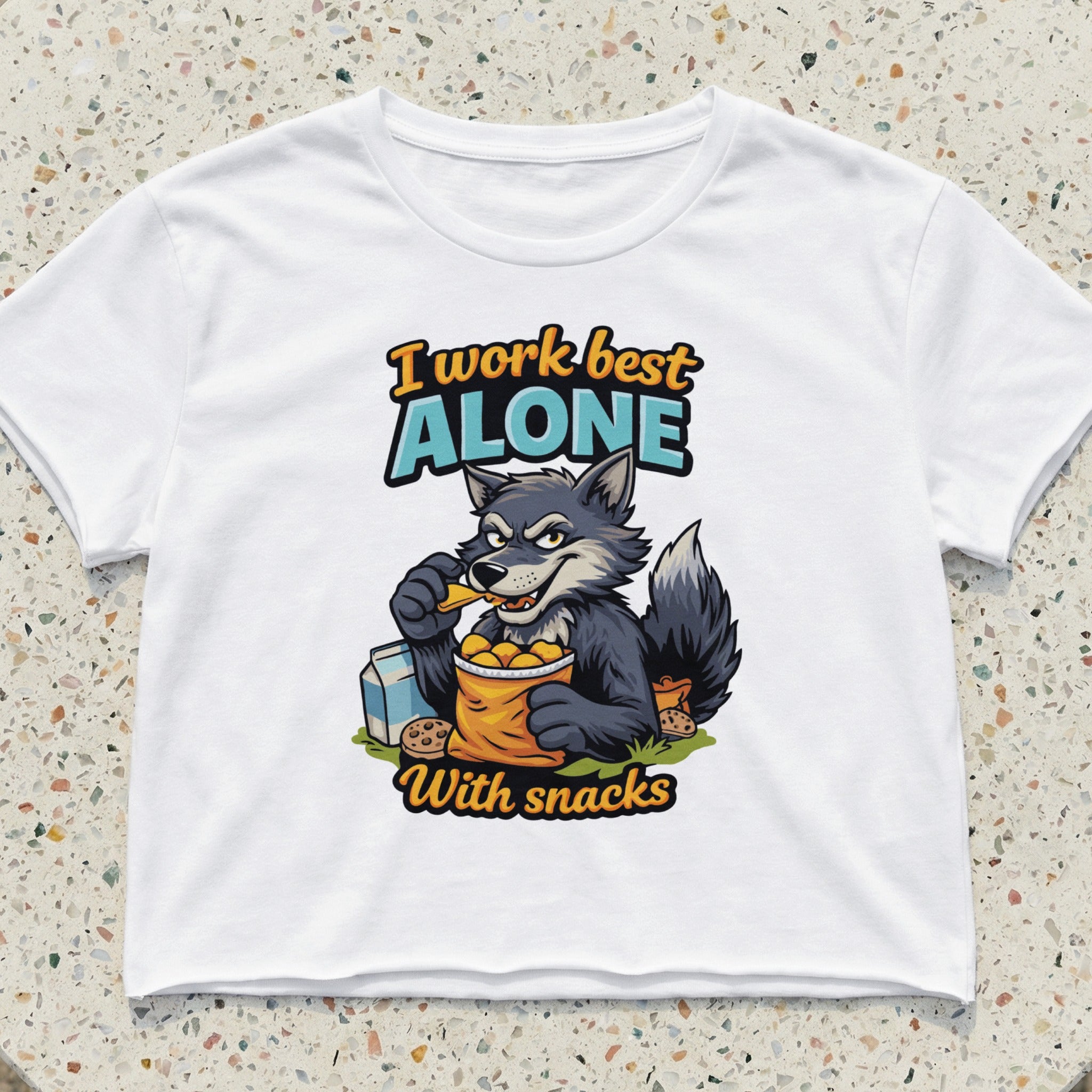 Graphic tee with cartoon wolf eating snacks and text "I work best alone with snacks".