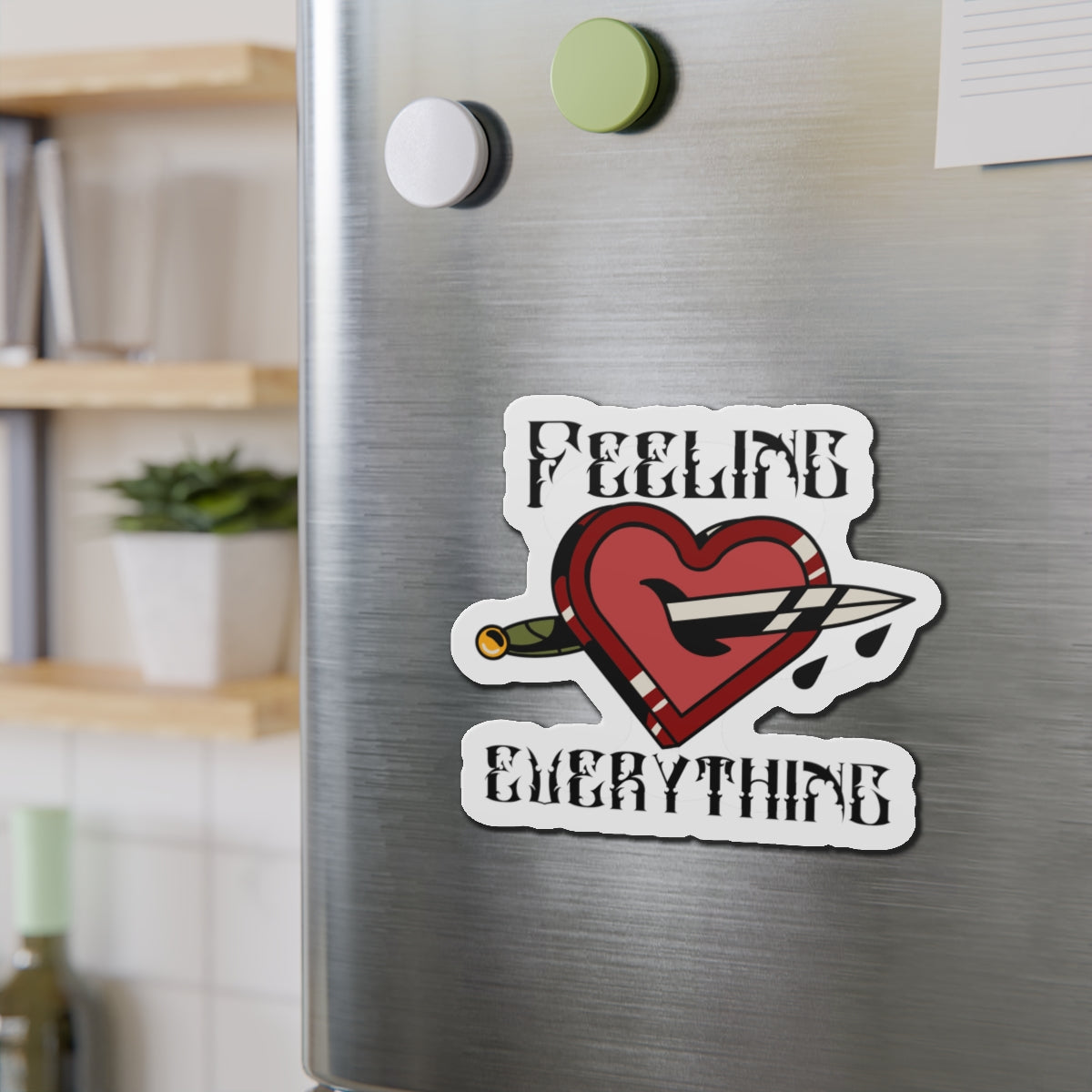 Magnet with a heart stabbed by a knife and text "FEELING EVERYTHING".