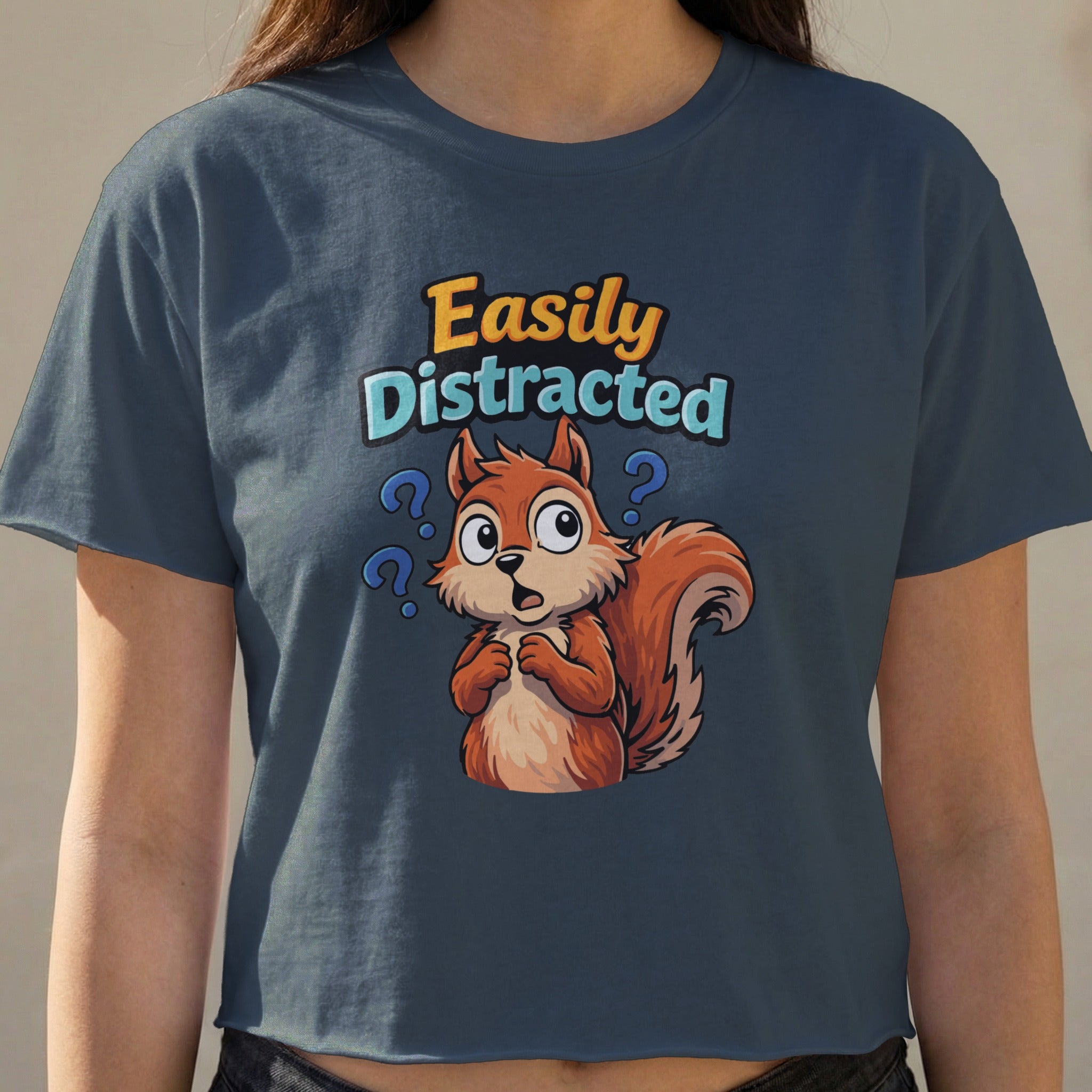 Squirrel cartoon with question marks and text "Easily Distracted".