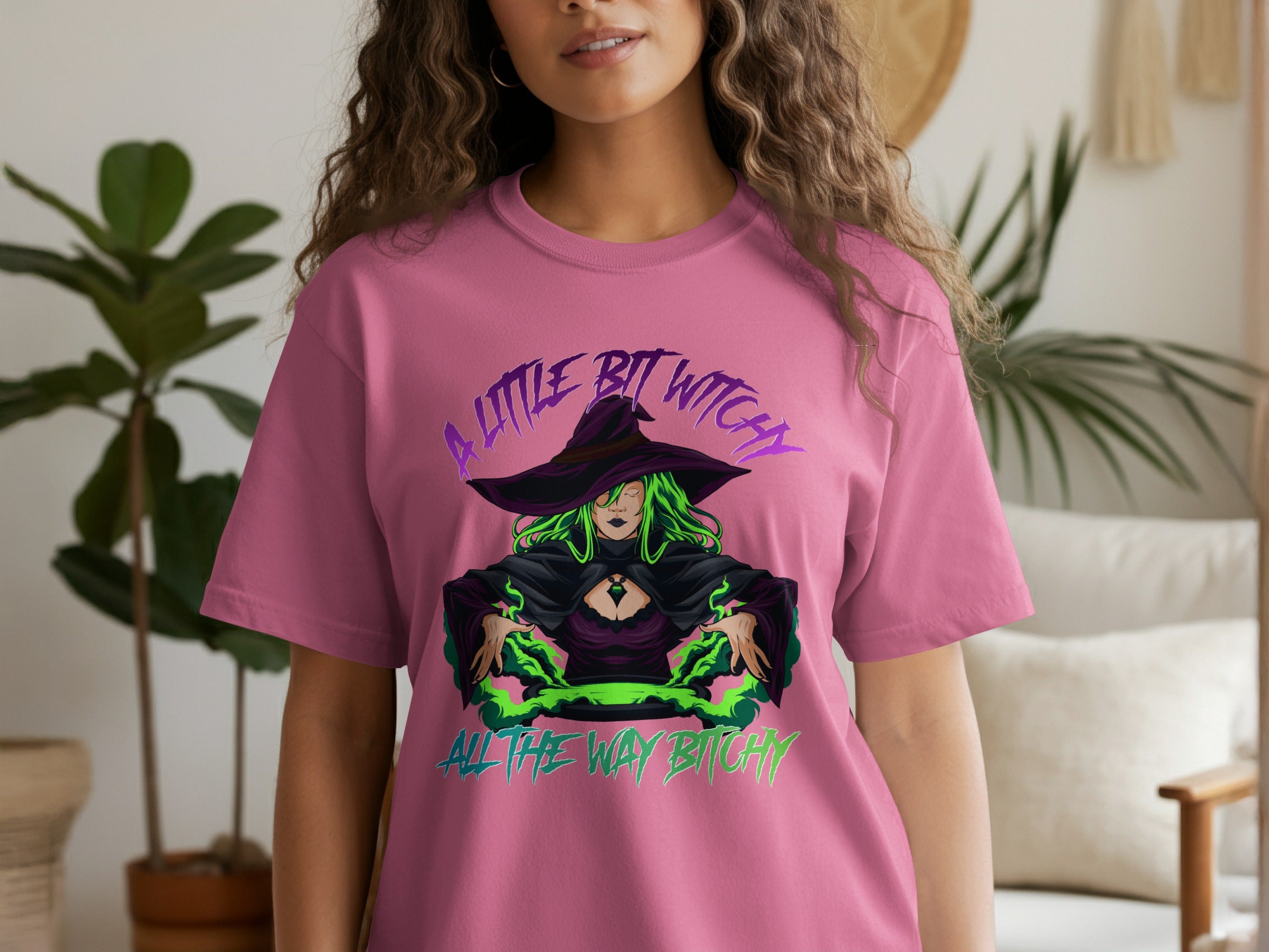 Pink t-shirt with purple text and witch illustration, "A little bit witchy all the way bitchy."