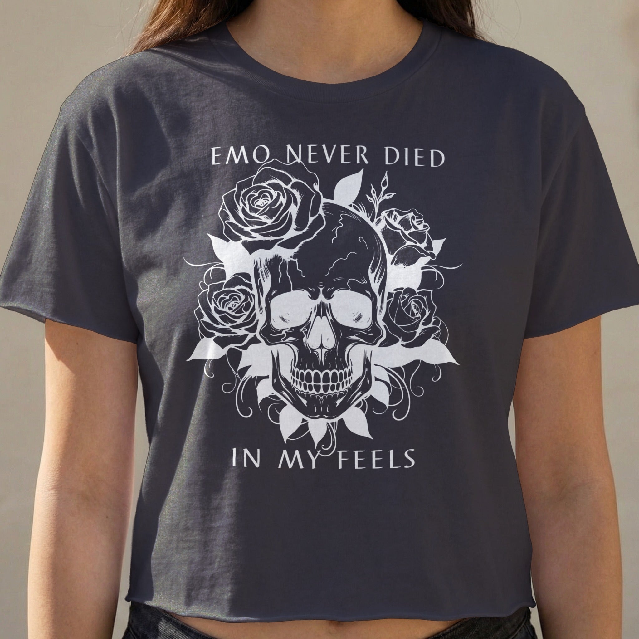 Dark t-shirt with skull and roses graphic and text "EMO NEVER DIED IN MY FEELS."