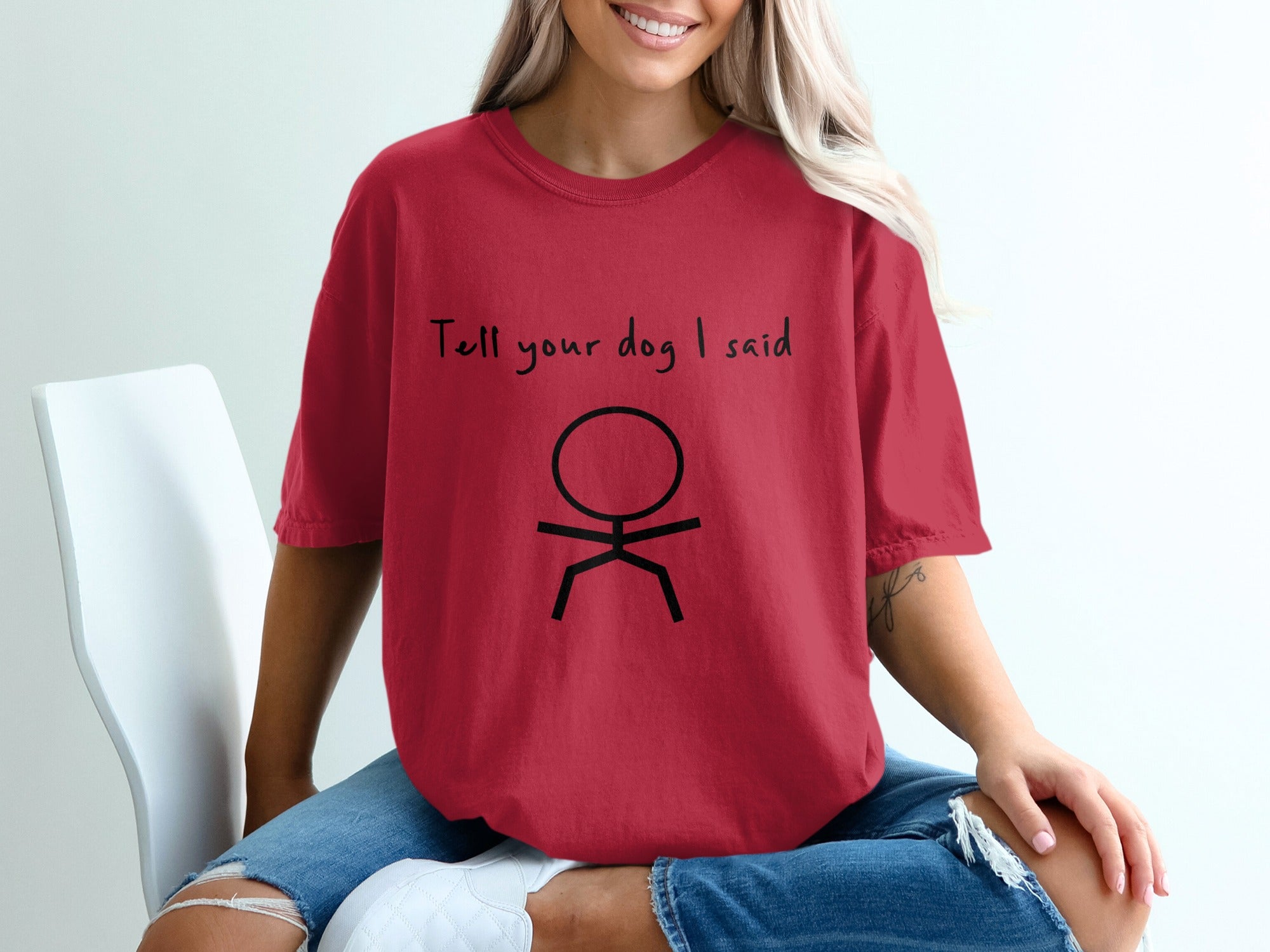 Red t-shirt with black stick figure and text "Tell your dog I said".