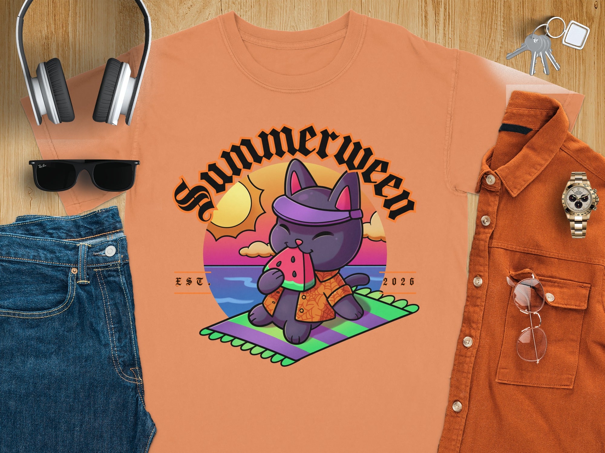 Black cat with "Summerween" text eating watermelon on a beach.